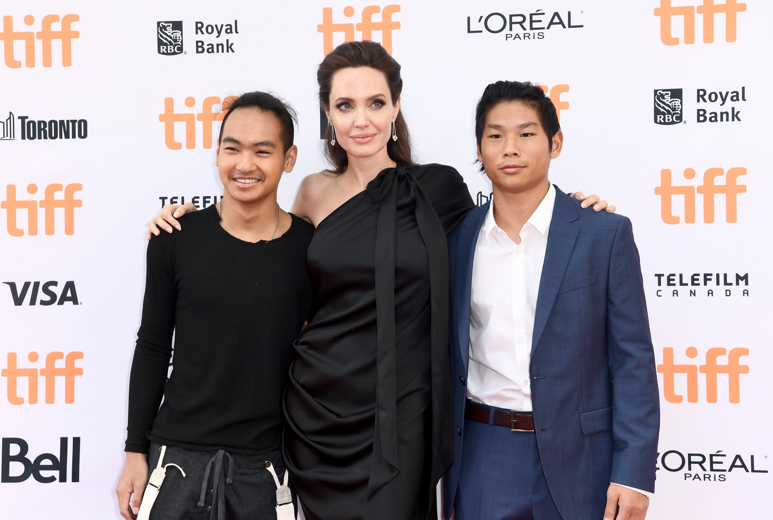 Maddox and Pax Jolie-Pitt with Angelina Jolie at the world premiere of "First They Killed My Father" during the Toronto International Film Festival at Princess of Wales Theatre on September 11, 2017, in Canada. | Source: Getty Images