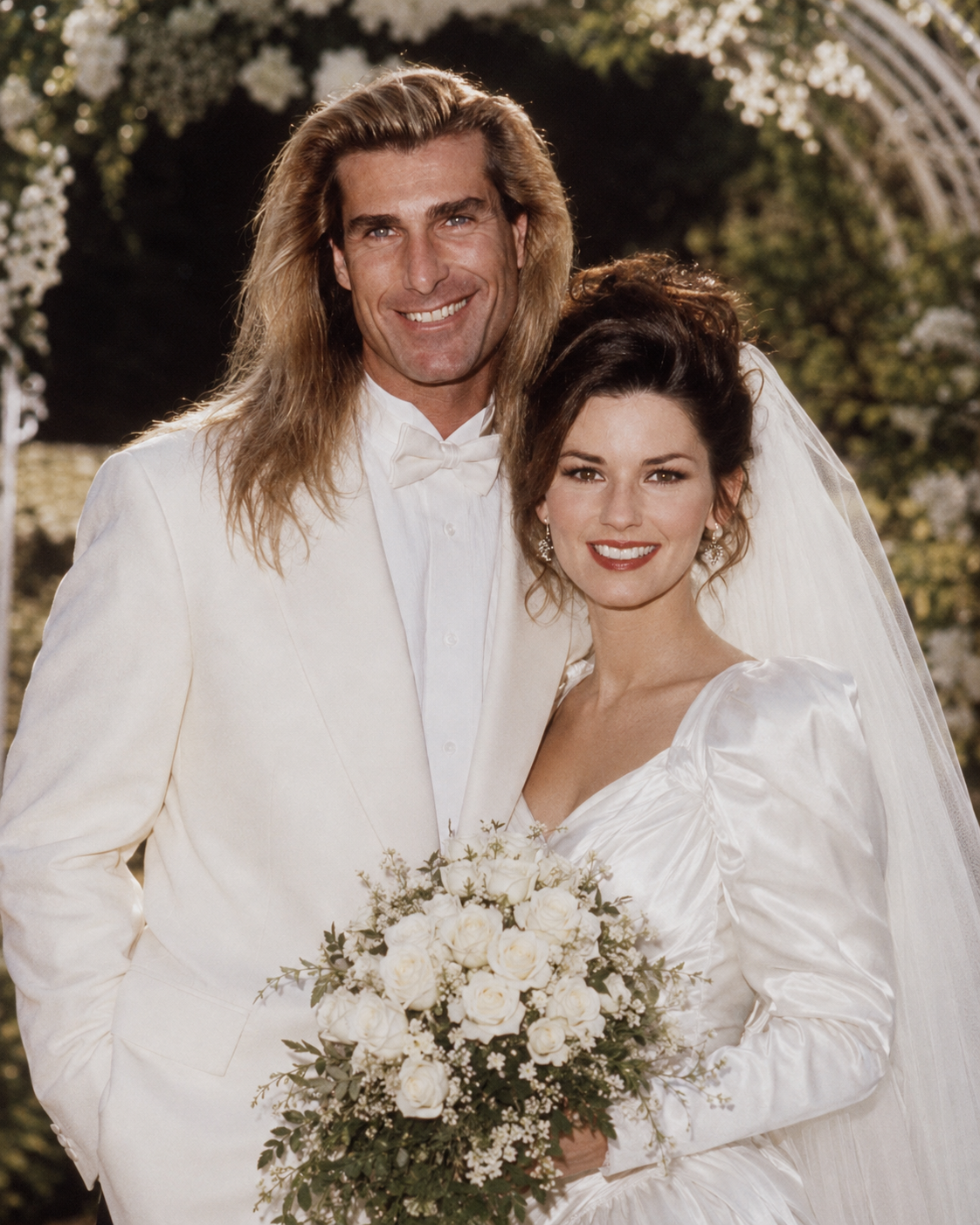 This AI creation features Fabio in a sleek white tuxedo alongside Shania Twain in a traditional satin bridal gown and veil, embodying typical country-pop wedding romance. | Source: ChatGPT