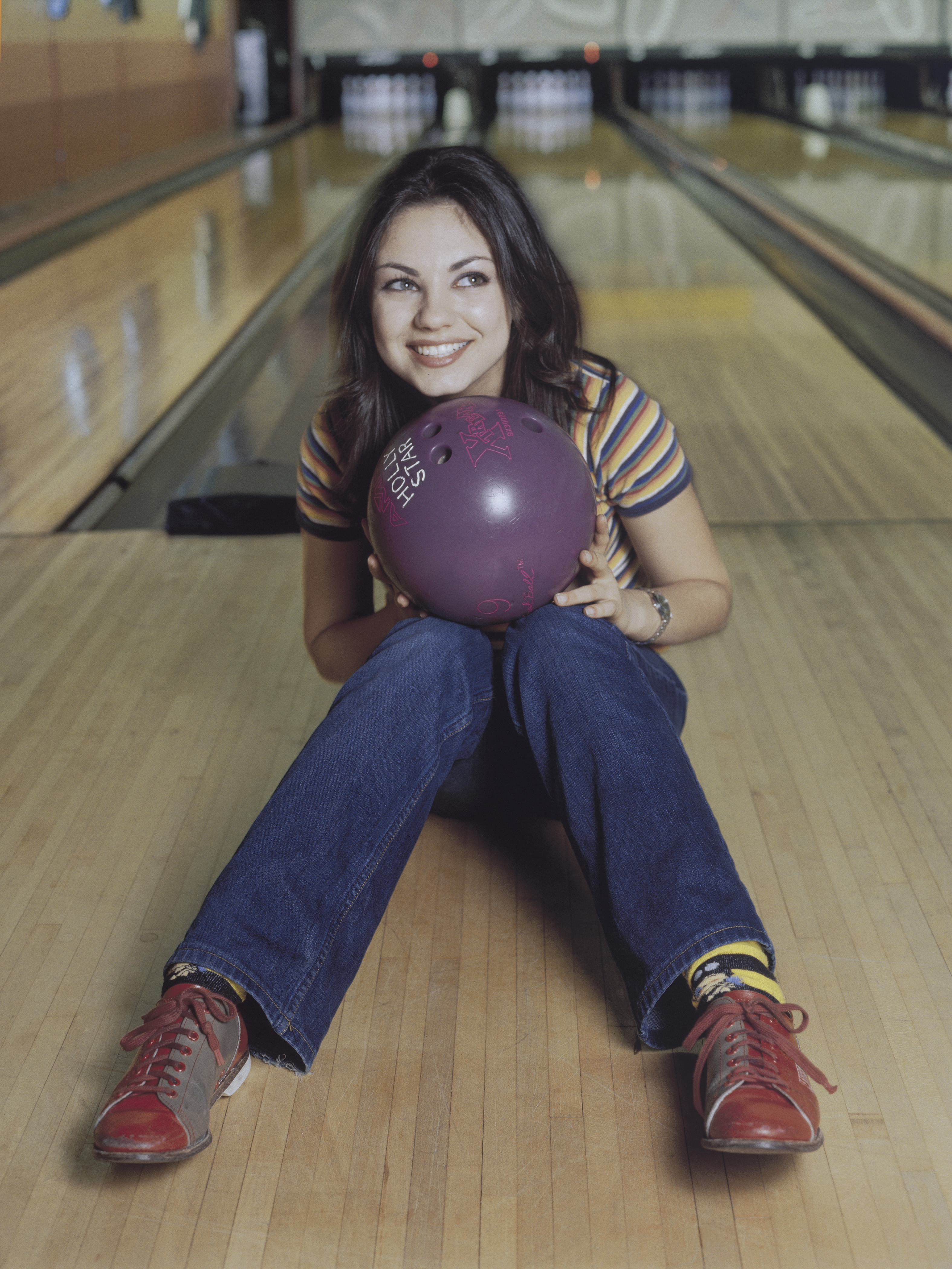 Actress Mila Kunis poses for a portrait at a bowling alley in 2006 in Hollywood, California. | Source: Getty Images