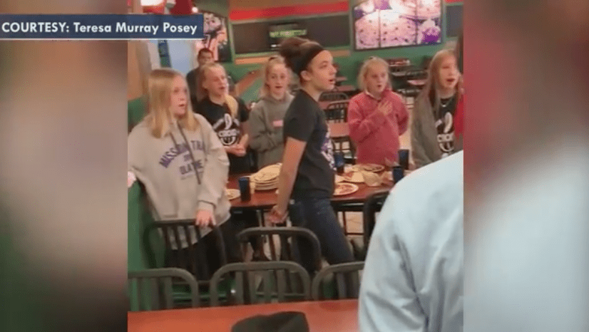 Middle school children singing to veteran Roy Fred Blackburn in a pizza joint. | Source: Fox News