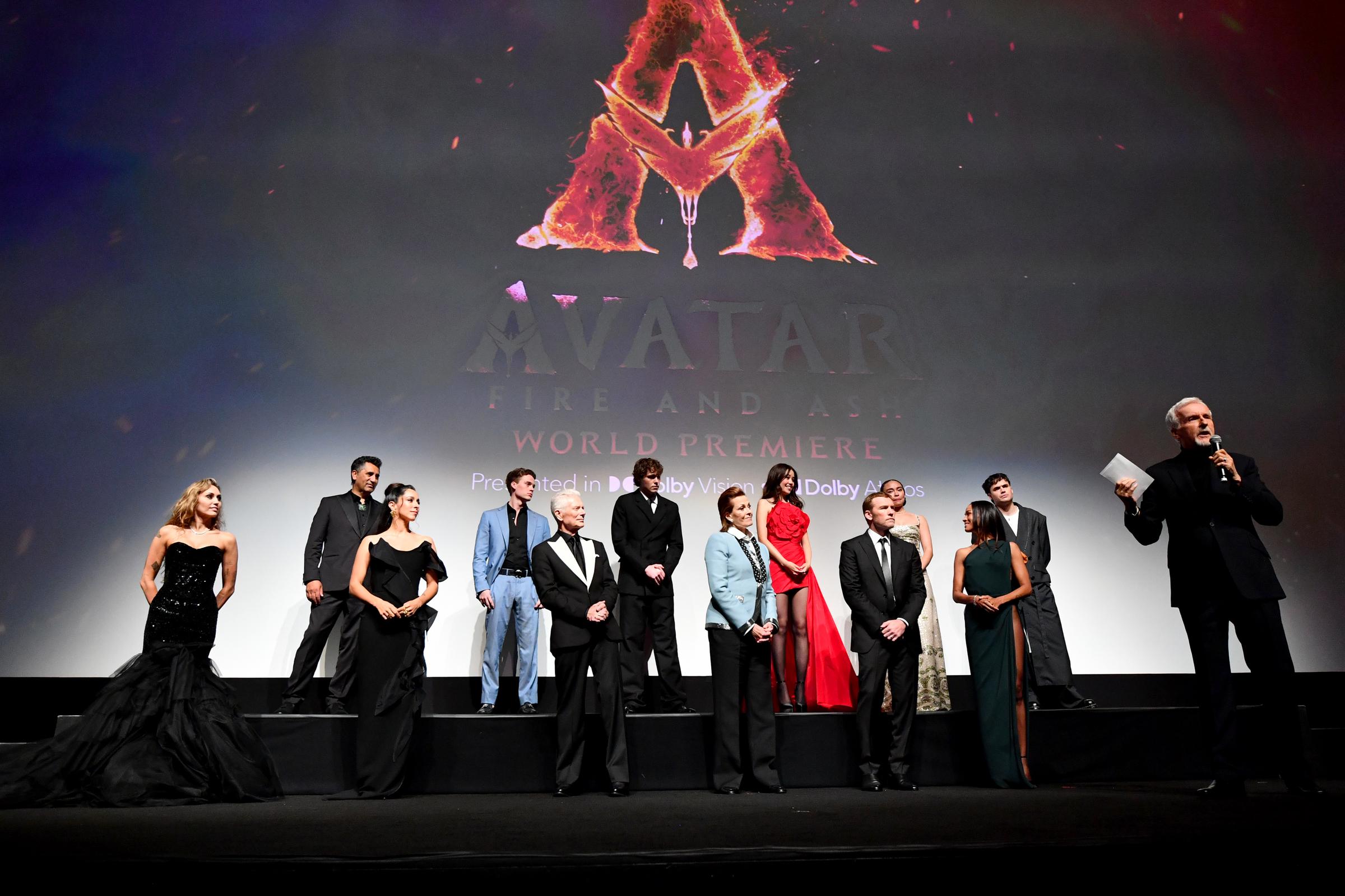 Miley Cyrus, Cliff Curtis, Oona Chaplin, Britain Dalton, Stephen Lang, Jack Champion, Sigourney Weaver, Trinity Jo-Li Bliss, Sam Worthington, Bailey Bass, Zoe Saldaña, Jamie Flatters, and James Cameron appear onstage at the world premiere.