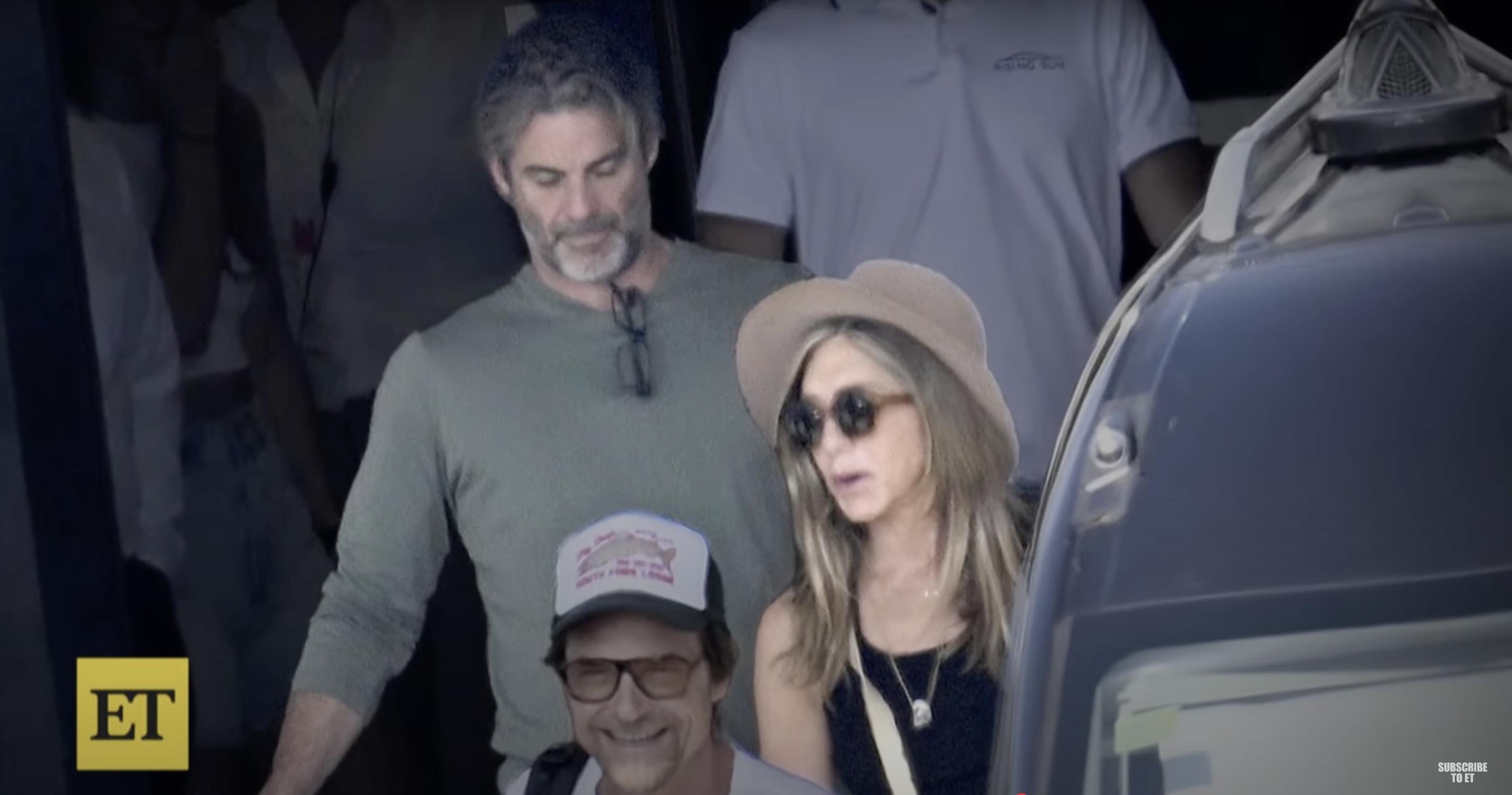 Jennifer Aniston was seen vacationing in Europe with rumored boyfriend Jim Curtis on July 10, 2025. She wore a sleeveless black top, wide-brimmed hat, and dark sunglasses while stepping out beside him. | Source: Entertainment Tonight