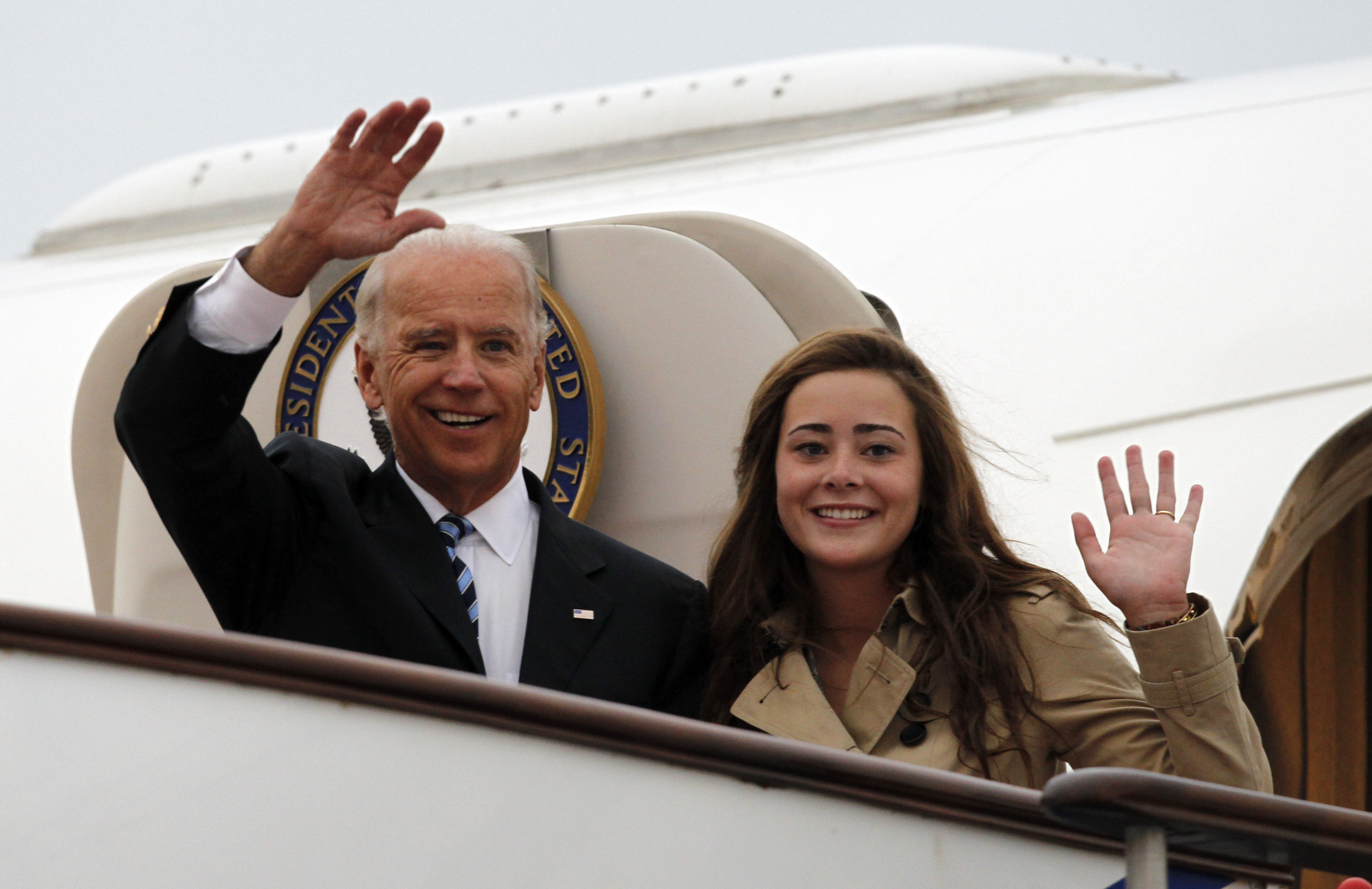 US Vice President Joe Biden with Naomi Biden as they walk out from Air Force Two upon arrival at the Beijing Capital International Airport on August 17, 2011, in Beijing, China | Source: Getty Images