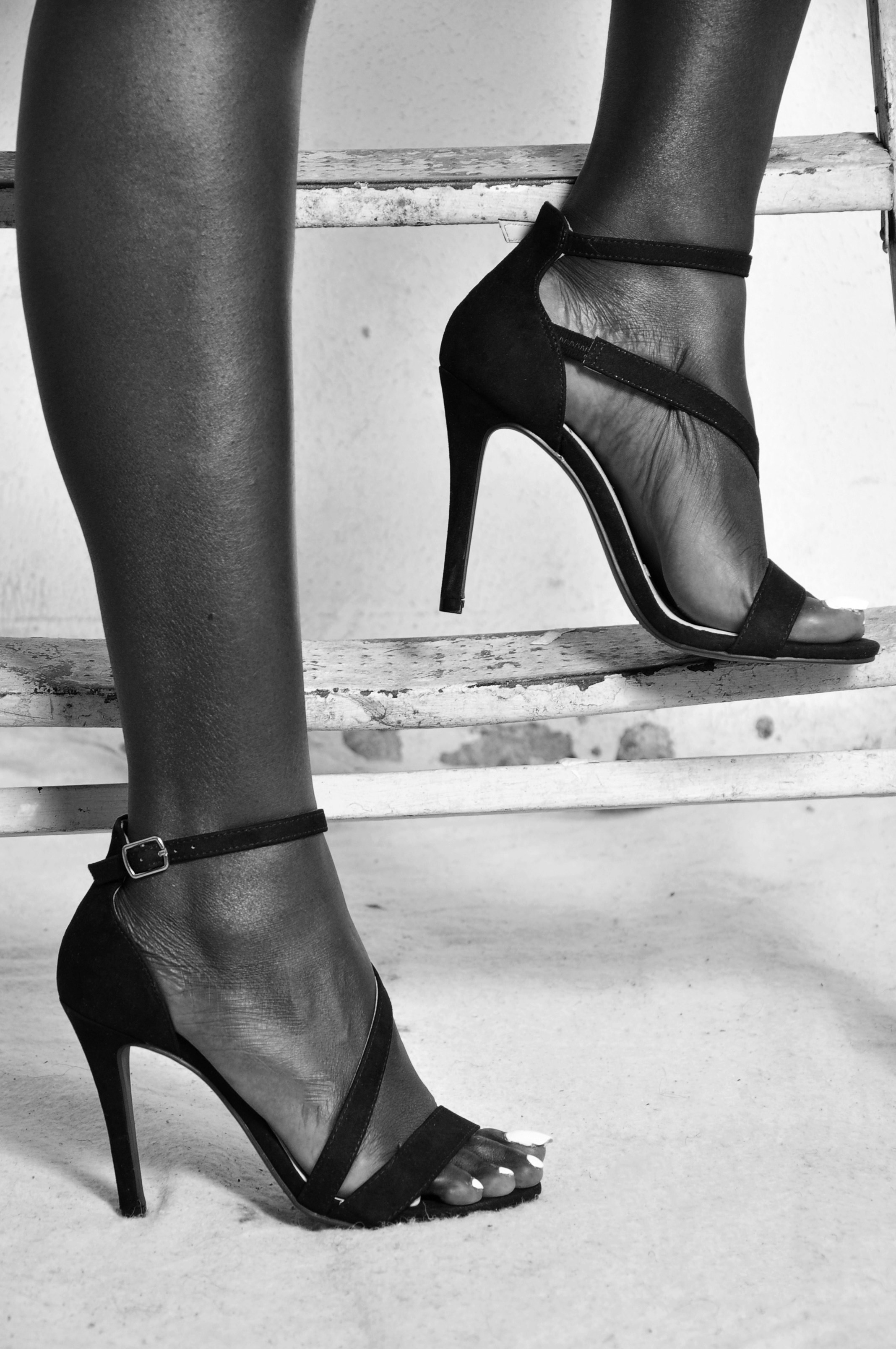 A person wearing heels and standing on the stairs | Source: Unsplash