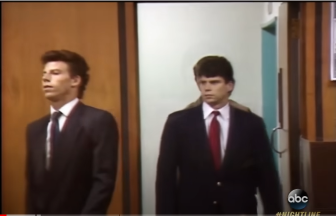 A photo of the Menendez brothers in black suits entering court taken from a video  posted on January 6, 2017 | Source: YouTube/@ABCNews