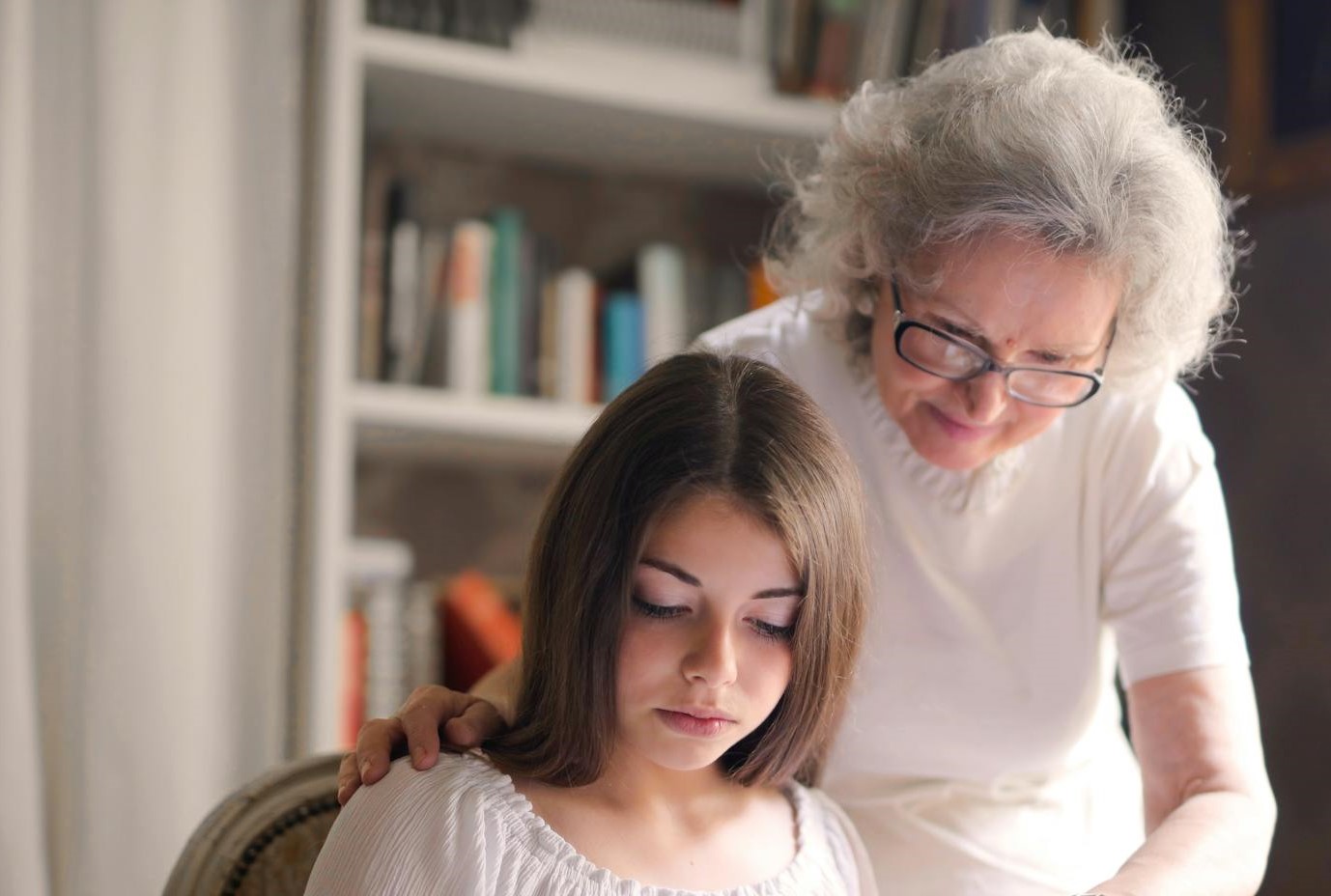 An older woman comforting her distressed granddaughter | Source: Pexels