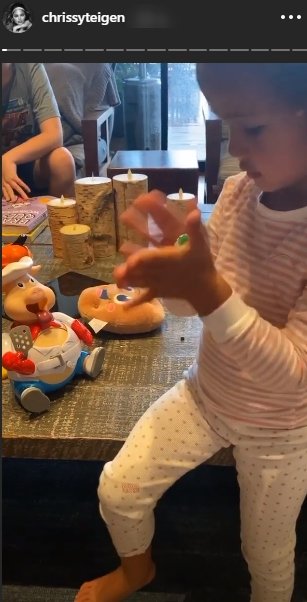 Chrissy Teigen shared a picture of her daughter, Luna Legend playing The Goliath Pop the Pig With Bonus 24pc/Puzzle game |Source: Instagram.com/chrissyteigen