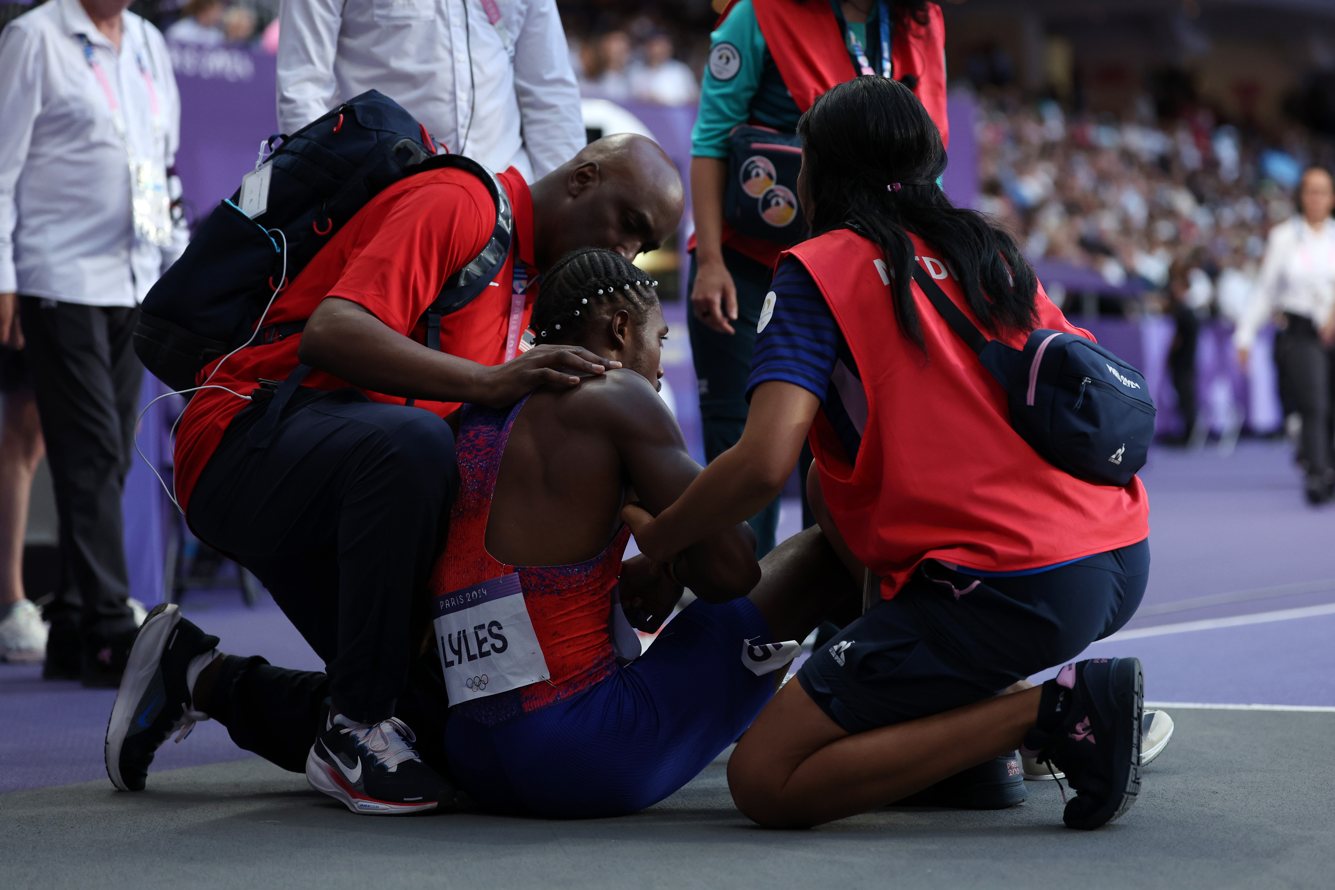 Noah Lyles of Team U.S. receiving medical assistance after competing in the Men's 200m Final at the Paris Olympic Games on August 8, 2024 | Source: Getty Images