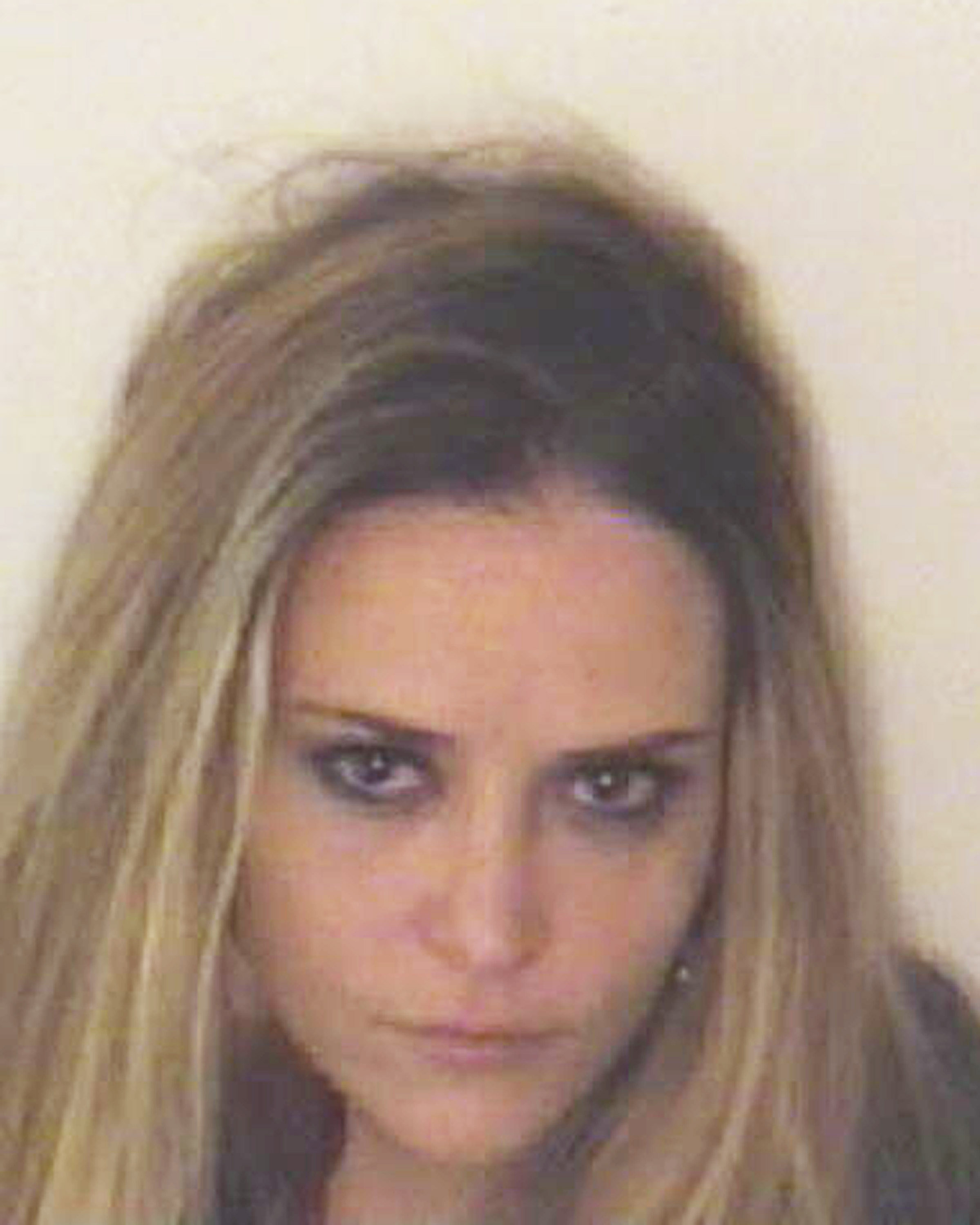 A handout photograph of 34-year-old Brooke Mueller posing for her mugshot after being arrested on December 3, 2011, in Aspen, Colorado | Source: Getty Images