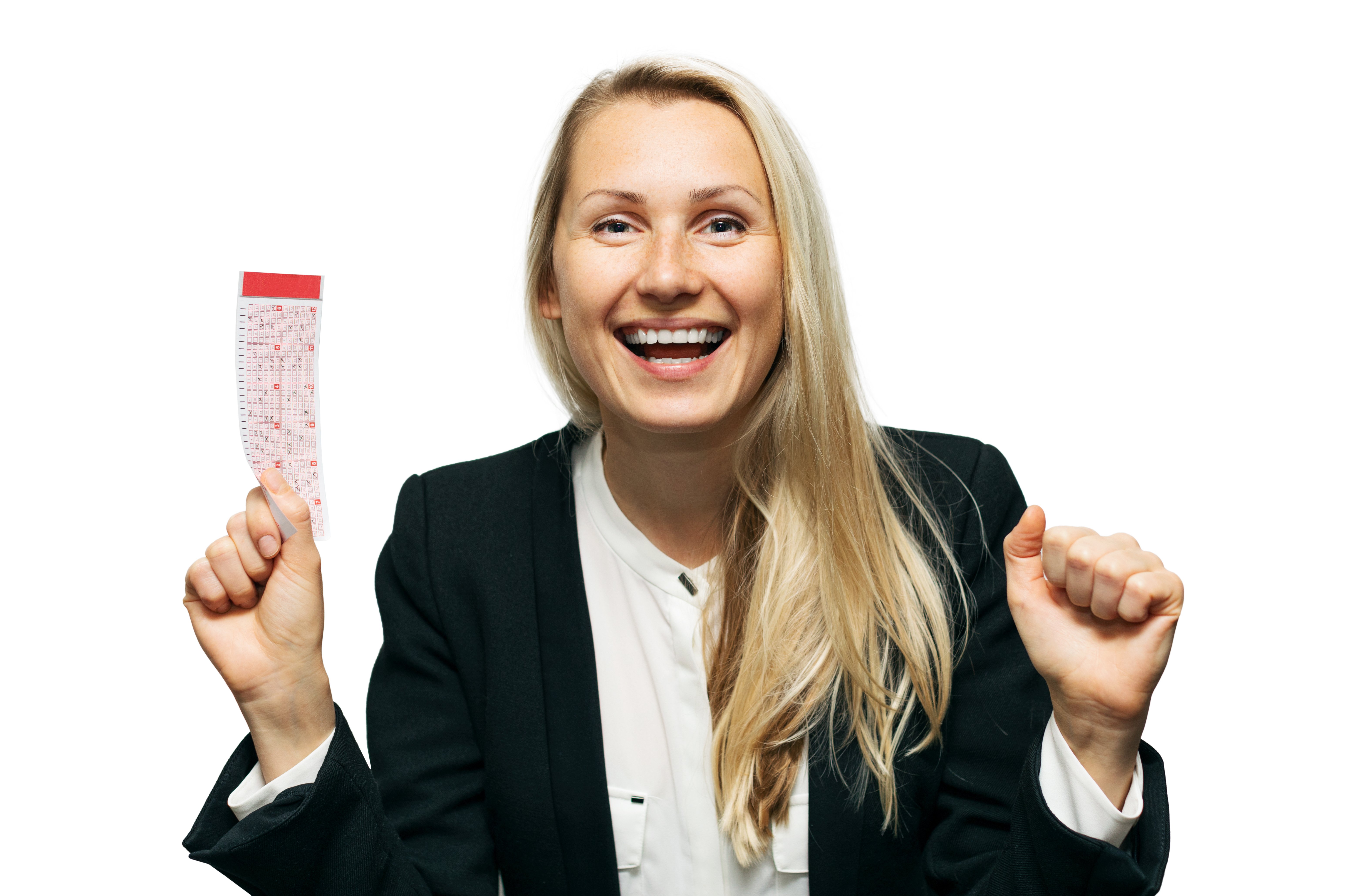 An ecstatic woman with a smile on her face holding a lottery ticket. | Photo: Shutterstock.