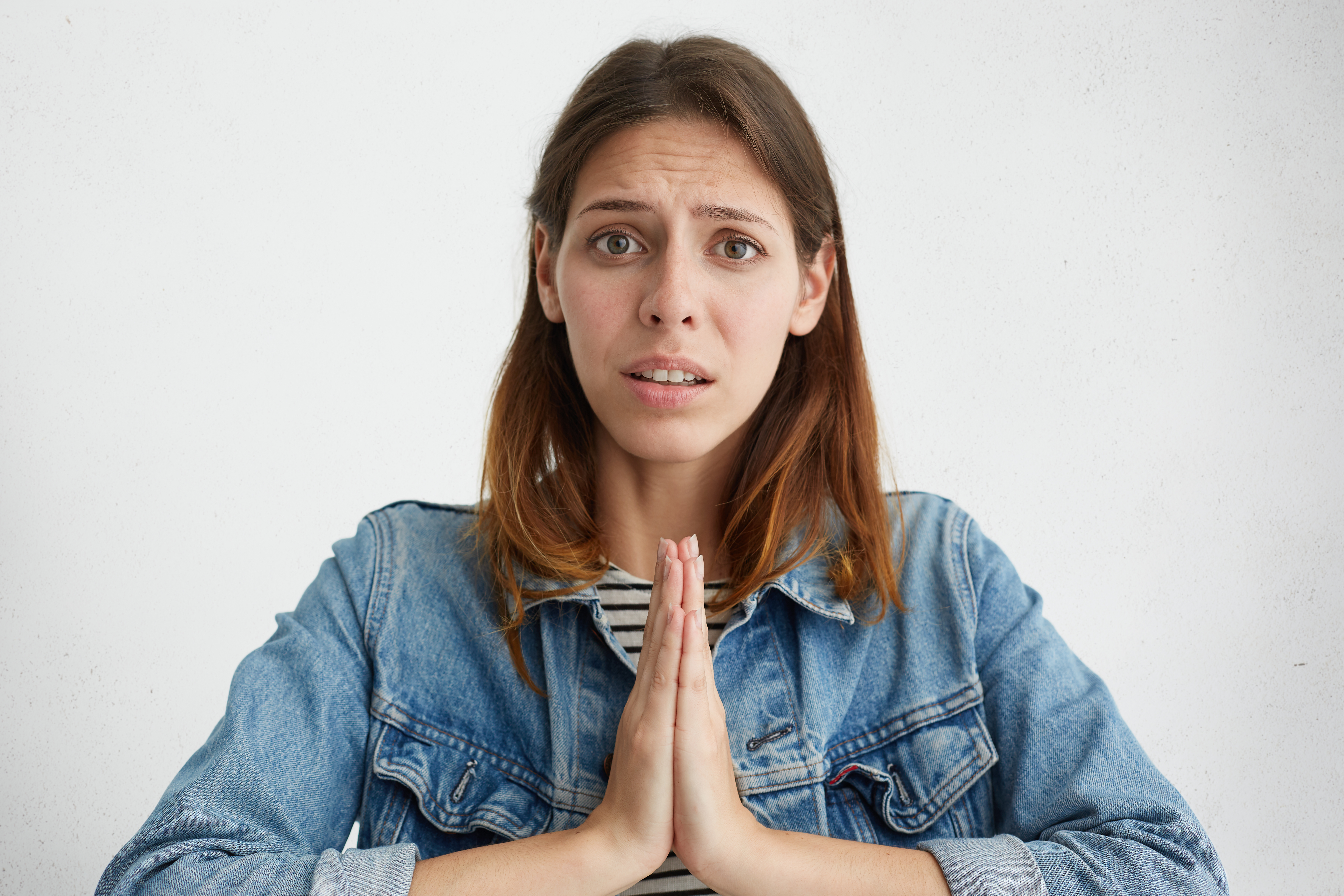 Woman begs for forgiveness | Shutterstock