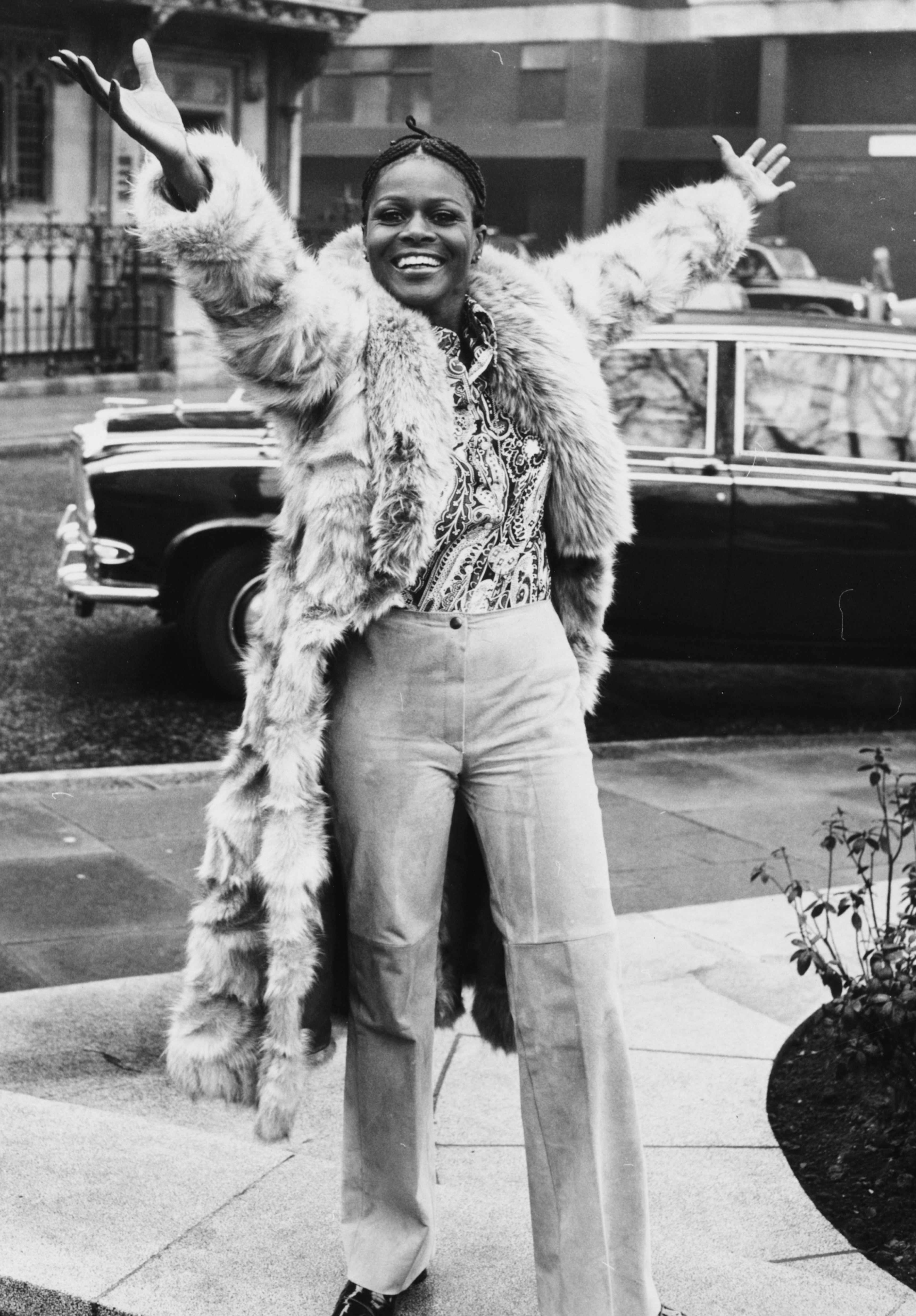 Cicely Tyson smiling and raising her arms in the air during a visit to London, February 19, 1973.| Source: Getty Images
