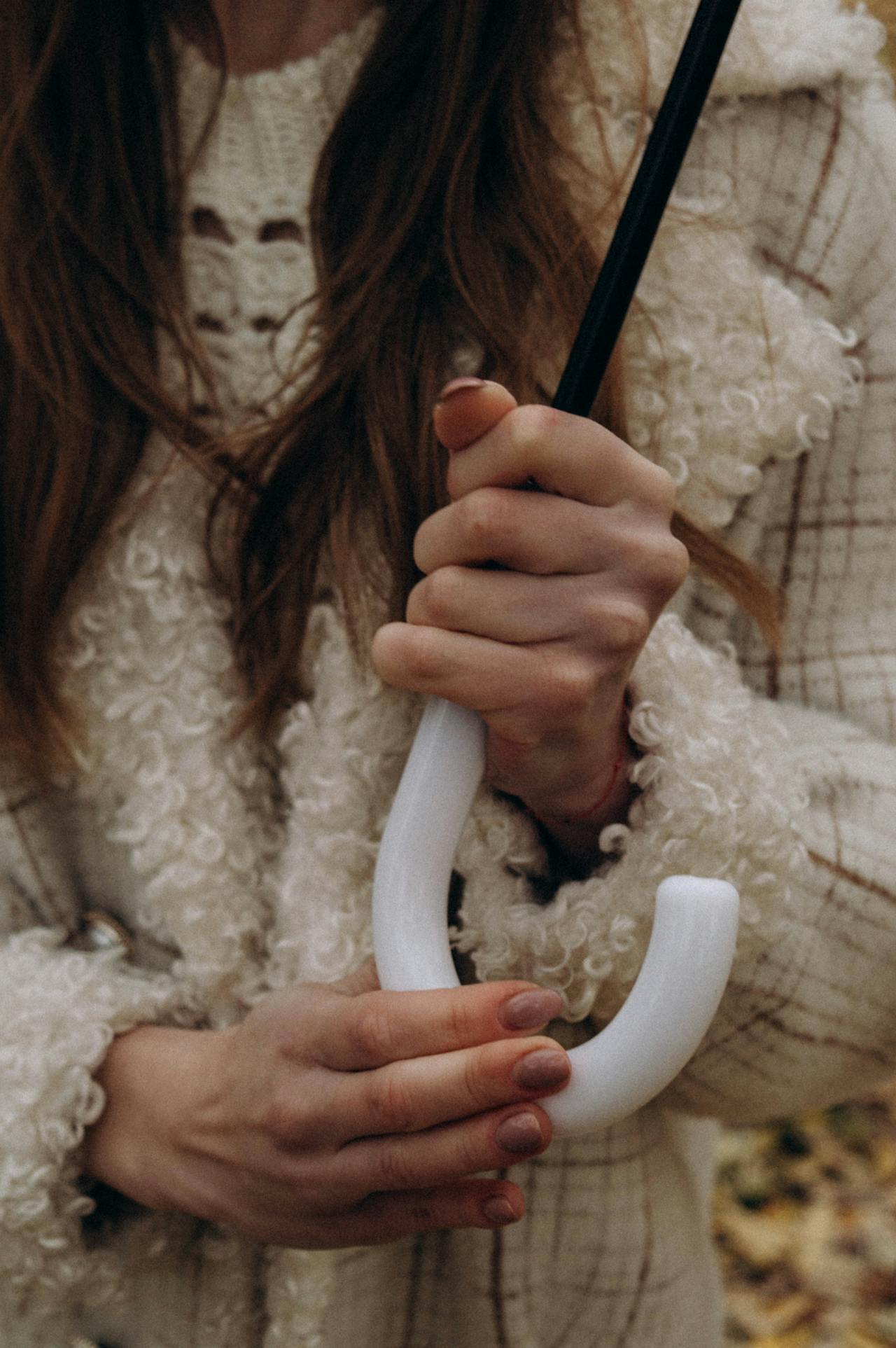 A woman holding an umbrella | Source: Pexels