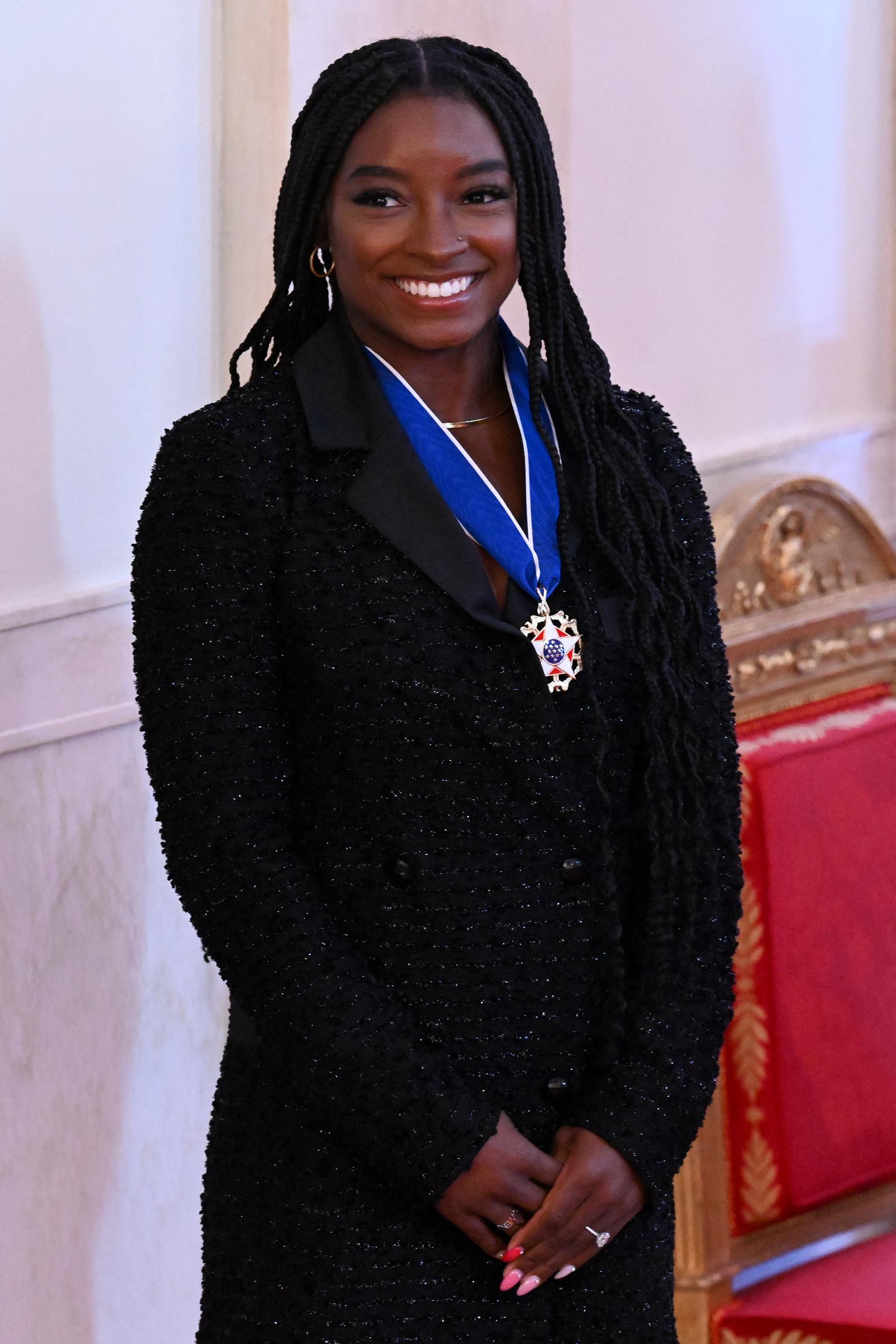 Biles stands proudly after receiving the Presidential Medal of Freedom during a ceremony at the White House on July 7, 2022. The gymnastics icon was among 17 recipients awarded the nation’s highest civilian honor for her extraordinary achievements and advocacy on and off the mat.