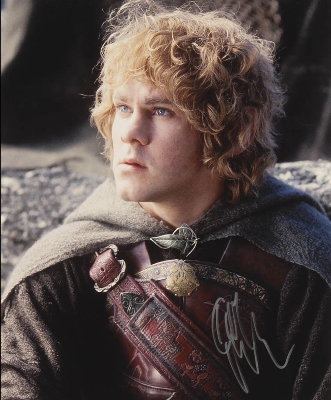 In "The Fellowship of the Ring," Dominic Monaghan portrayed Meriadoc Brandybuck, or Merry — the sharp-witted Hobbit whose bravery and loyalty shone through as the stakes grew higher. Clad in Elven cloaks and Gondorian armour, Monaghan brought both heart and humour to a character who rose to meet the burden of war with unexpected courage. | Source: The Fellowship of the Ring