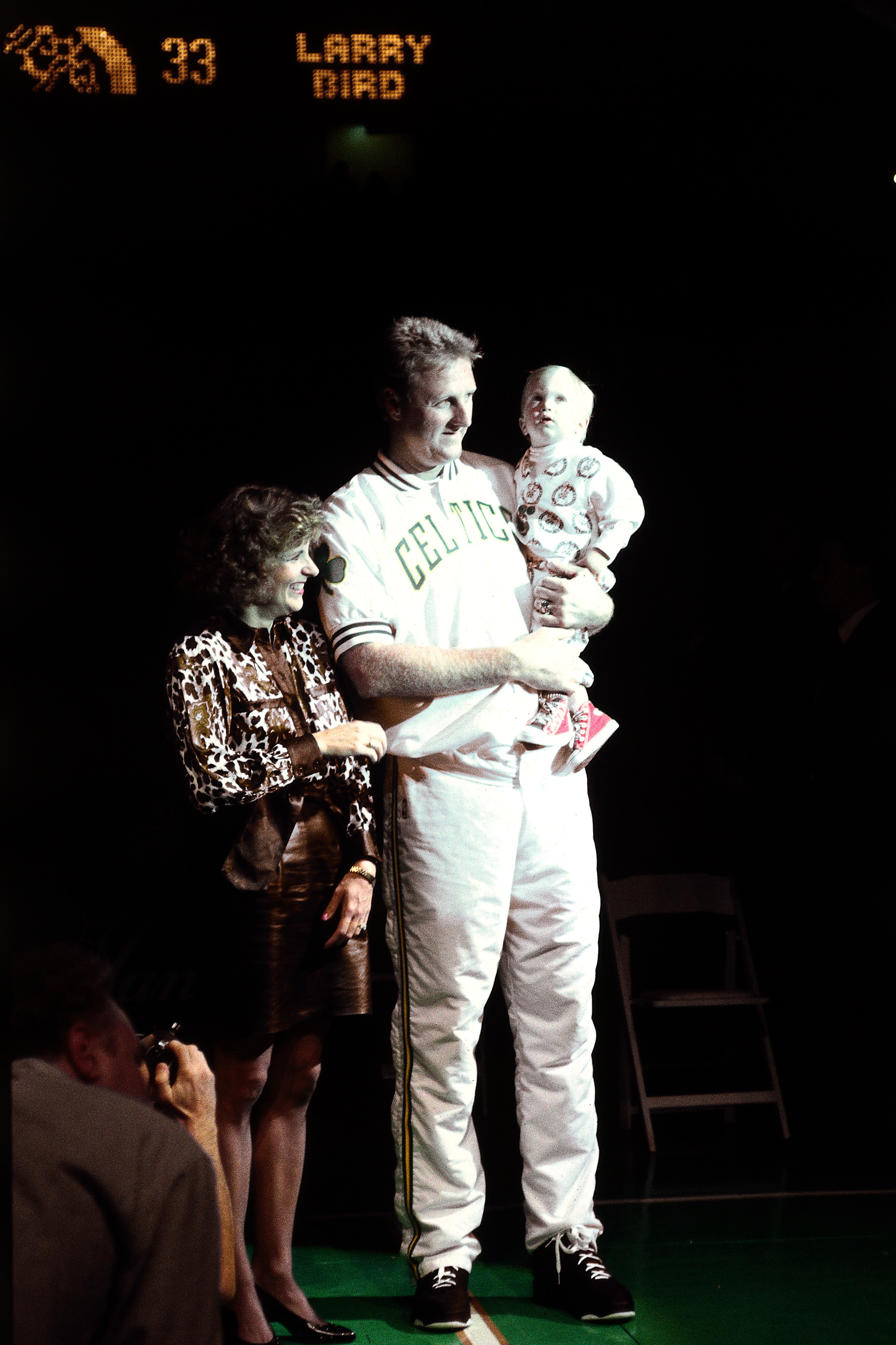 Larry Bird carries their son Connor as he stands beside his wife Dinah at the Boston Garden on February 4, 1993, in Boston, Massachusetts. | Source: Getty Images