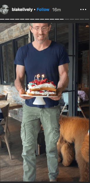 Ryan Reynolds holding a birthday cake as shown on Blake Lively's Instagram Story. | Photo: instagram.com/blakelively