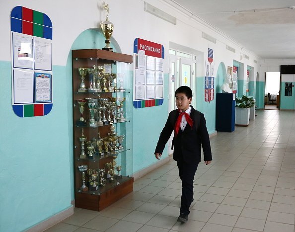 A young school boy in the hallway of a secondary school | Photo: Getty Images