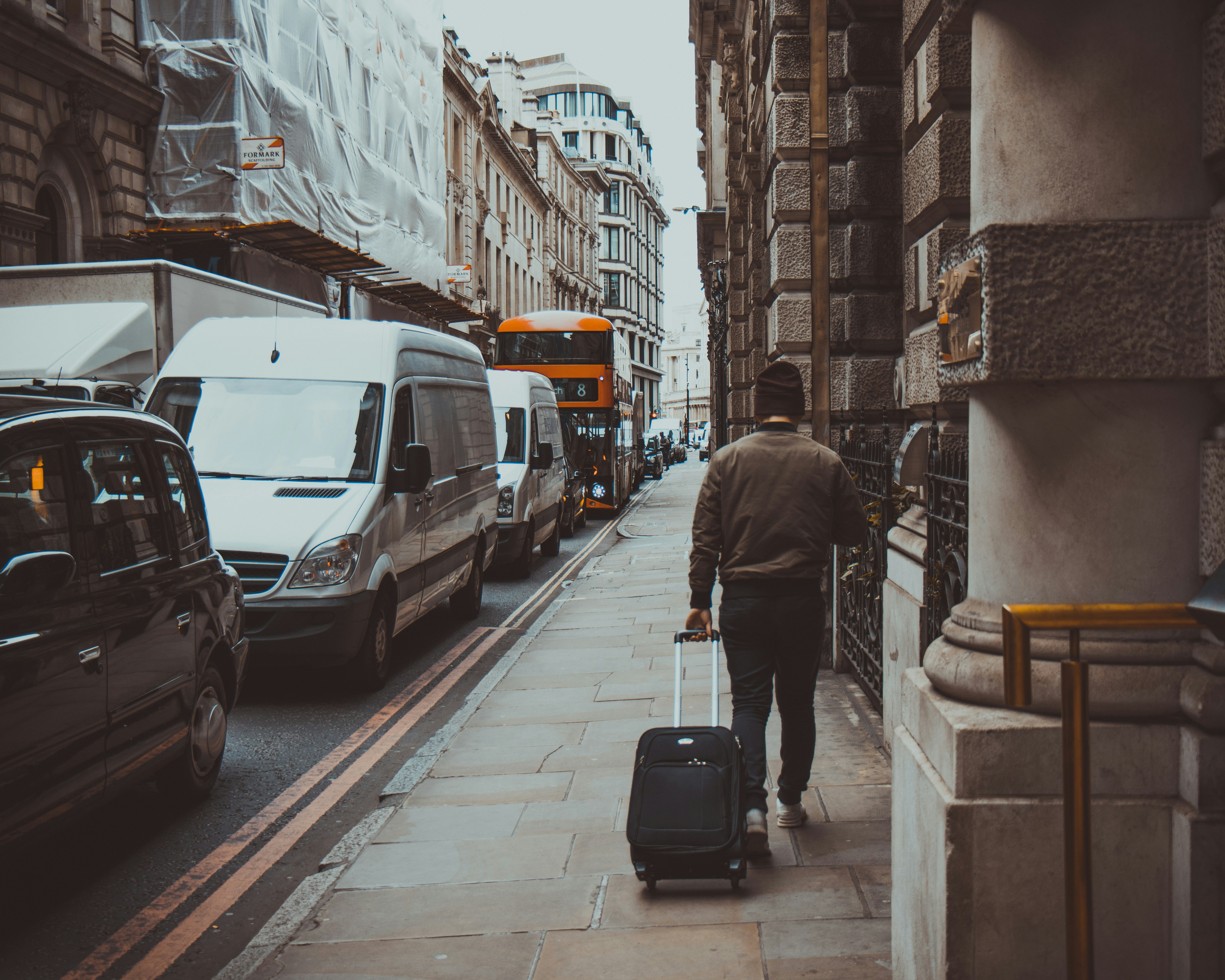 A man walking with a suitcase | Source: Unsplash