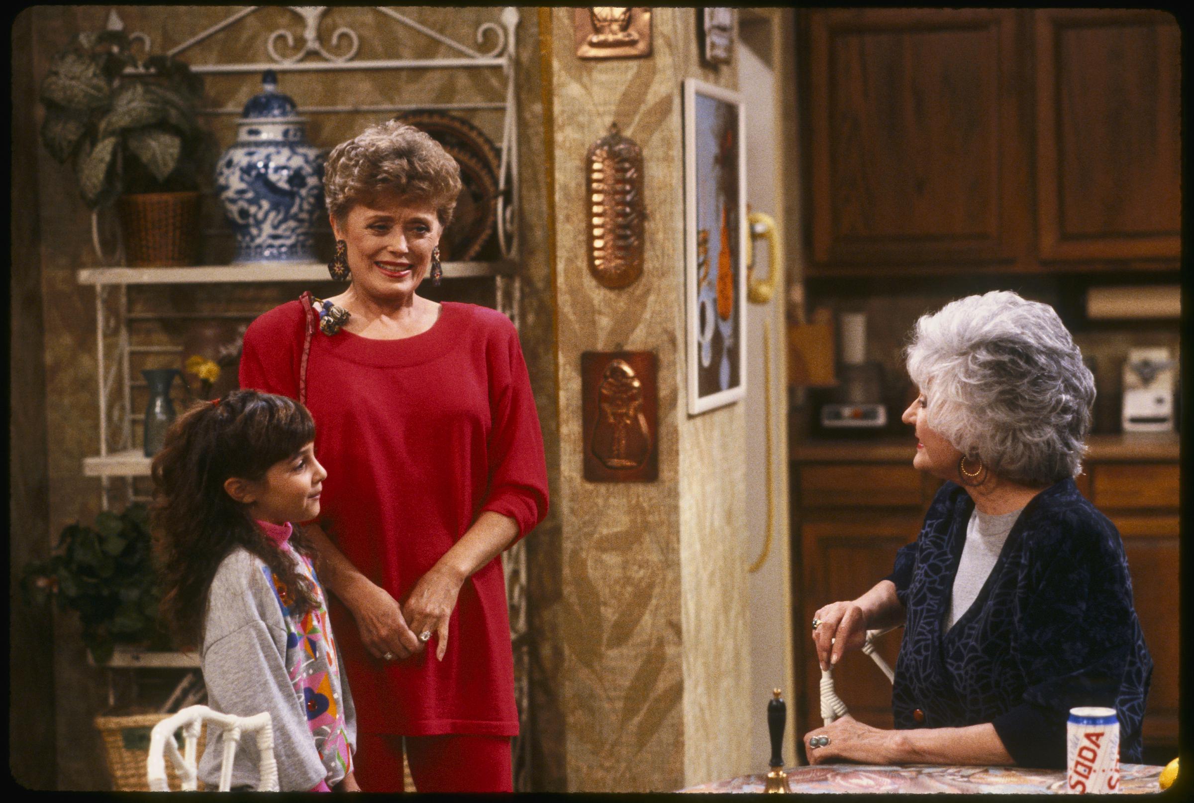 The child star, Rue McClanahan, and Bea Arthur on "The Golden Girls" in 1992. | Source: Getty Images