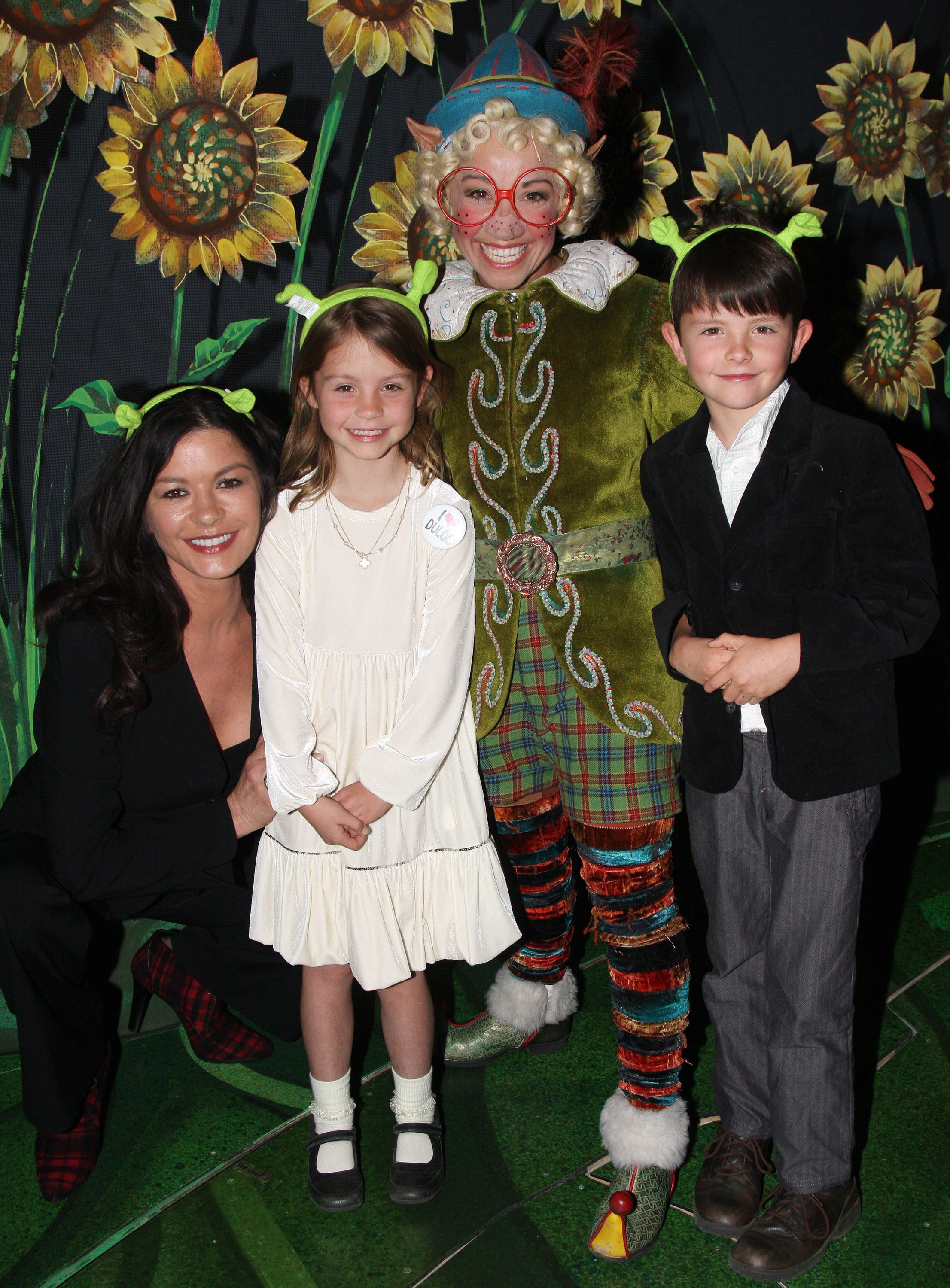 Catherine Zeta-Jones, Jen Cody as "The Elf", Carys Zeta Douglas and Dylan Michael Douglas pose backstage at "Shrek:The Musical" on Broadway at the Broadway Theatre on March 21, 2009 in New York City | Source: Getty Images