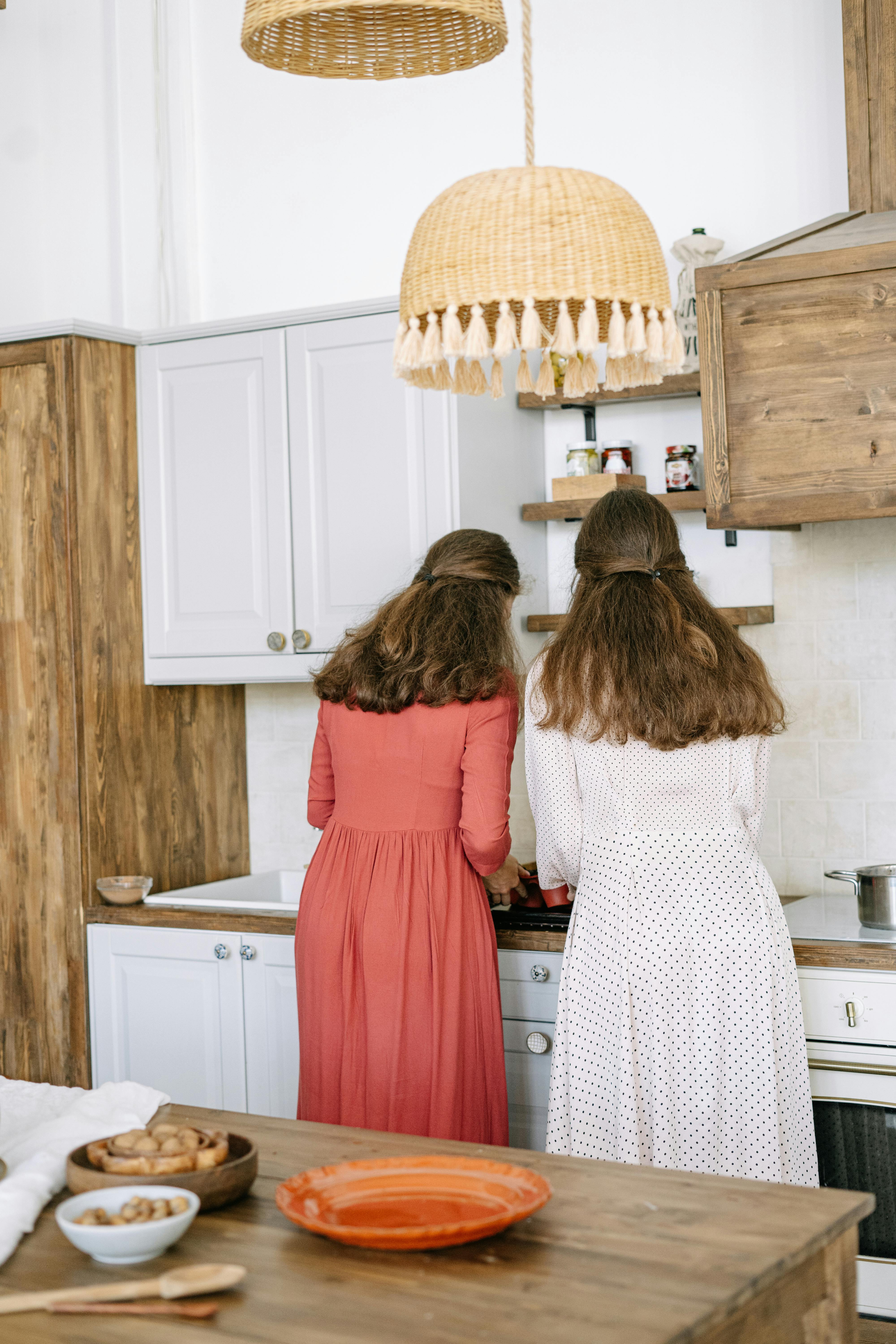 Two women standing in the kitchen | Source: Pexels