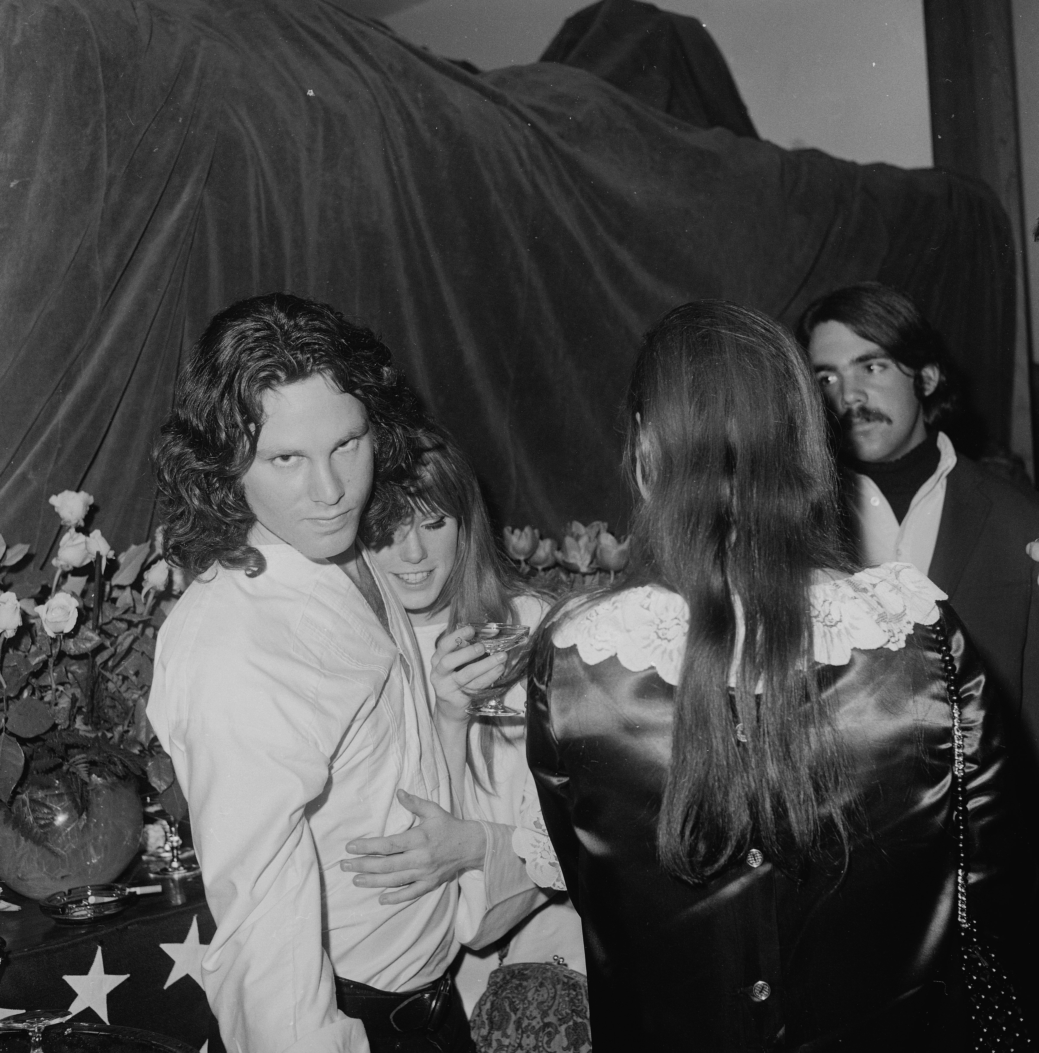 American musician and singer (L-R) Jim Morrison (1943 - 1971) and Pamela Courson (1946 - 1974) embrace at the opening of 'The Beard' at the Warner Playhouse, California, January 24, 1968.| Source: Getty Images