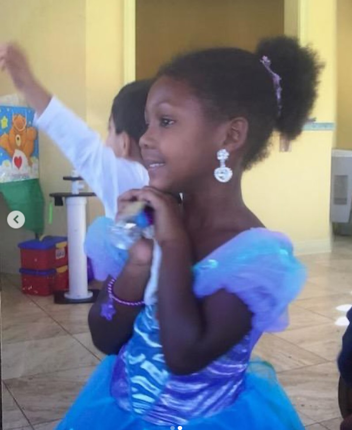 Young Isan Elba smiles softly while dressed in a shimmering blue princess-style costume, from a post dated January 4, 2024. | Source: Instagram/isanelba