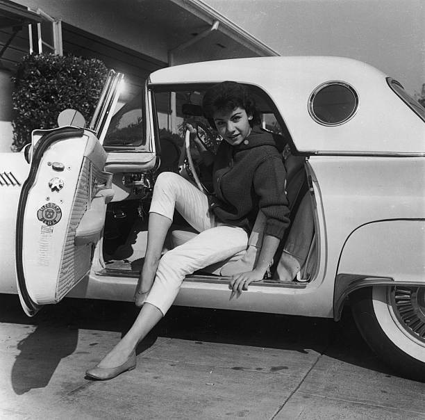 Annette Funicello posing while preparing to exit a Ford Thunderbird, circa 1955 | Source: Getty Images