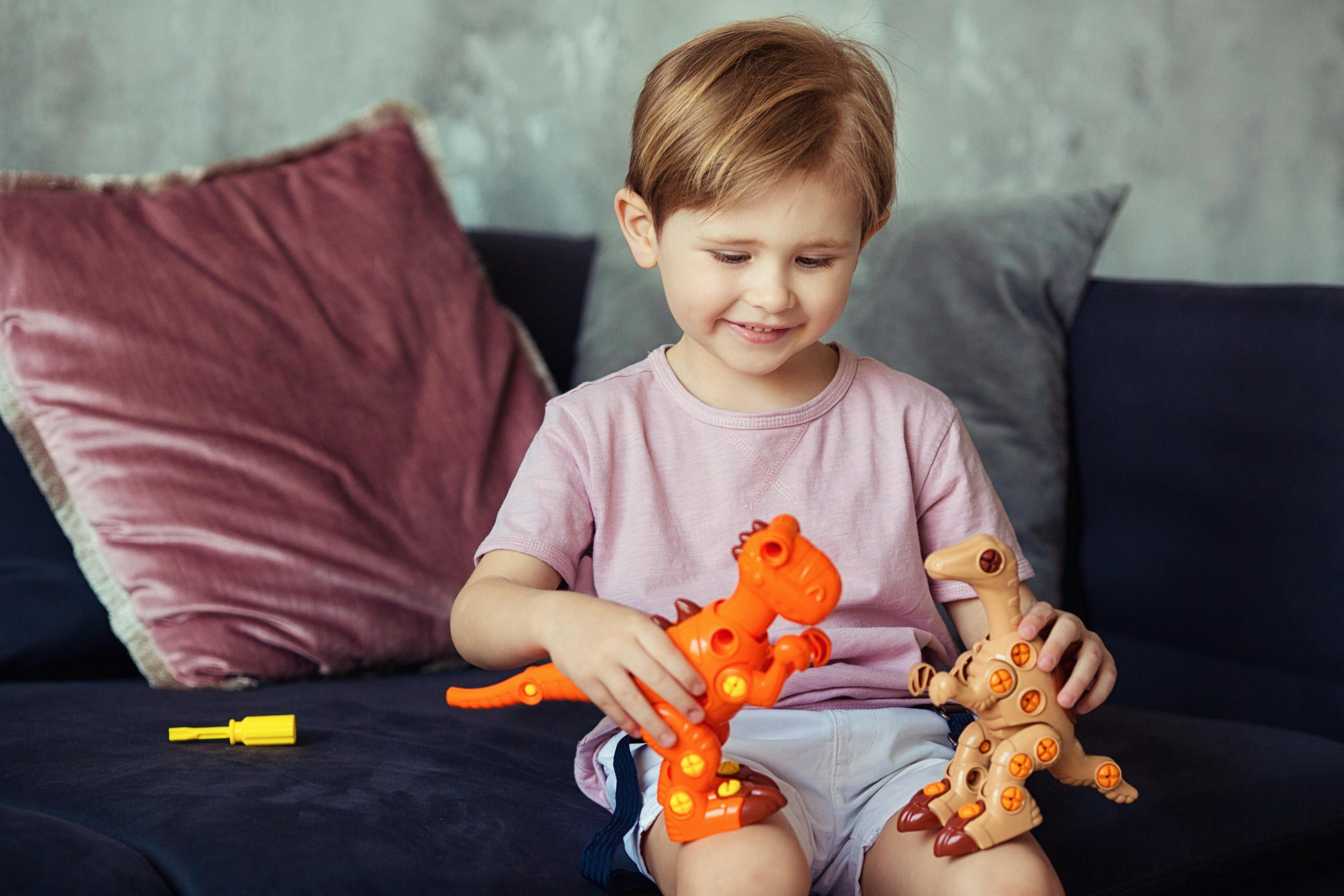 A child playing with dinosaur toys | Source: Pexels