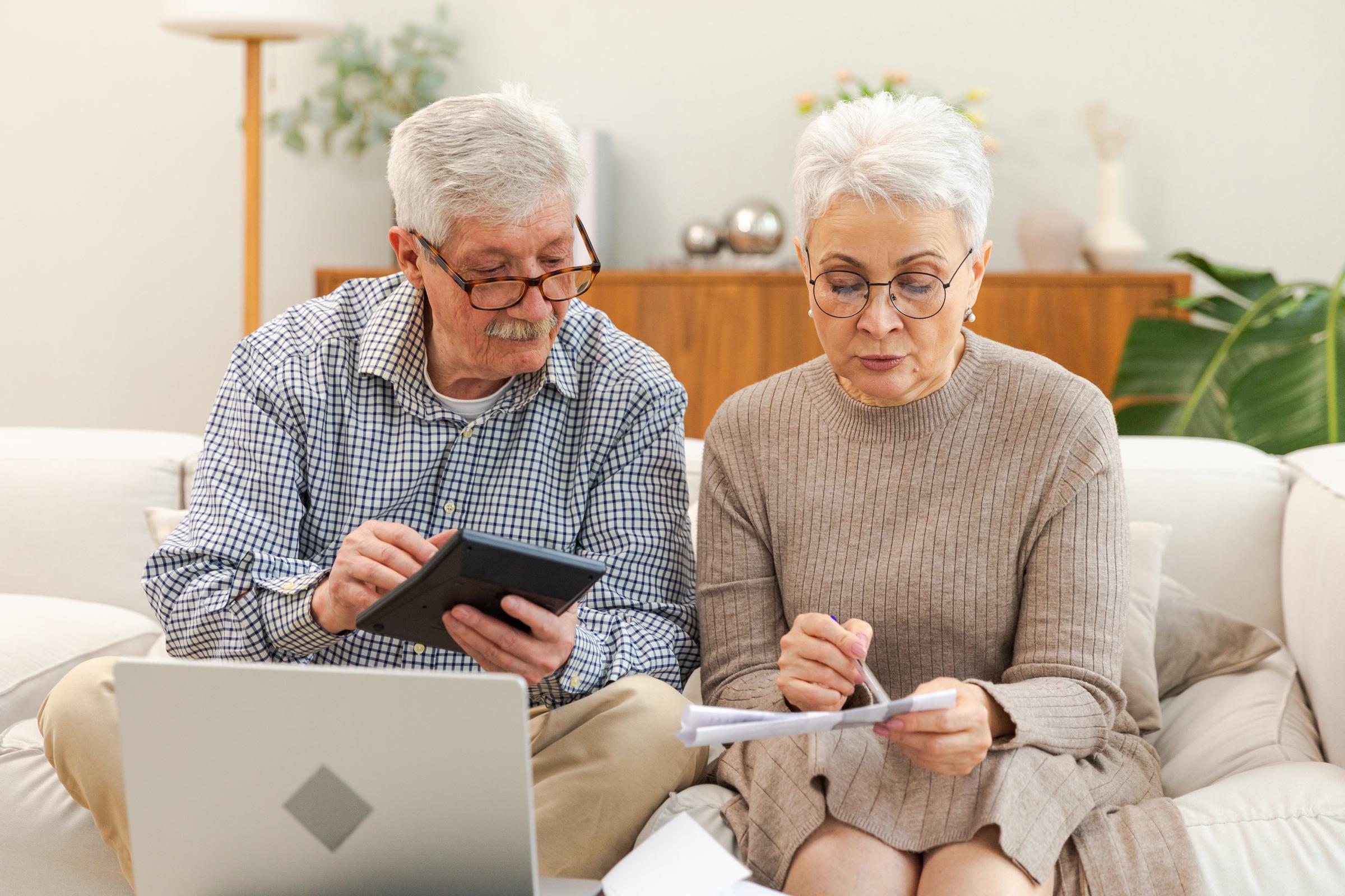 A senior couple going over some figures | Source: Shutterstock