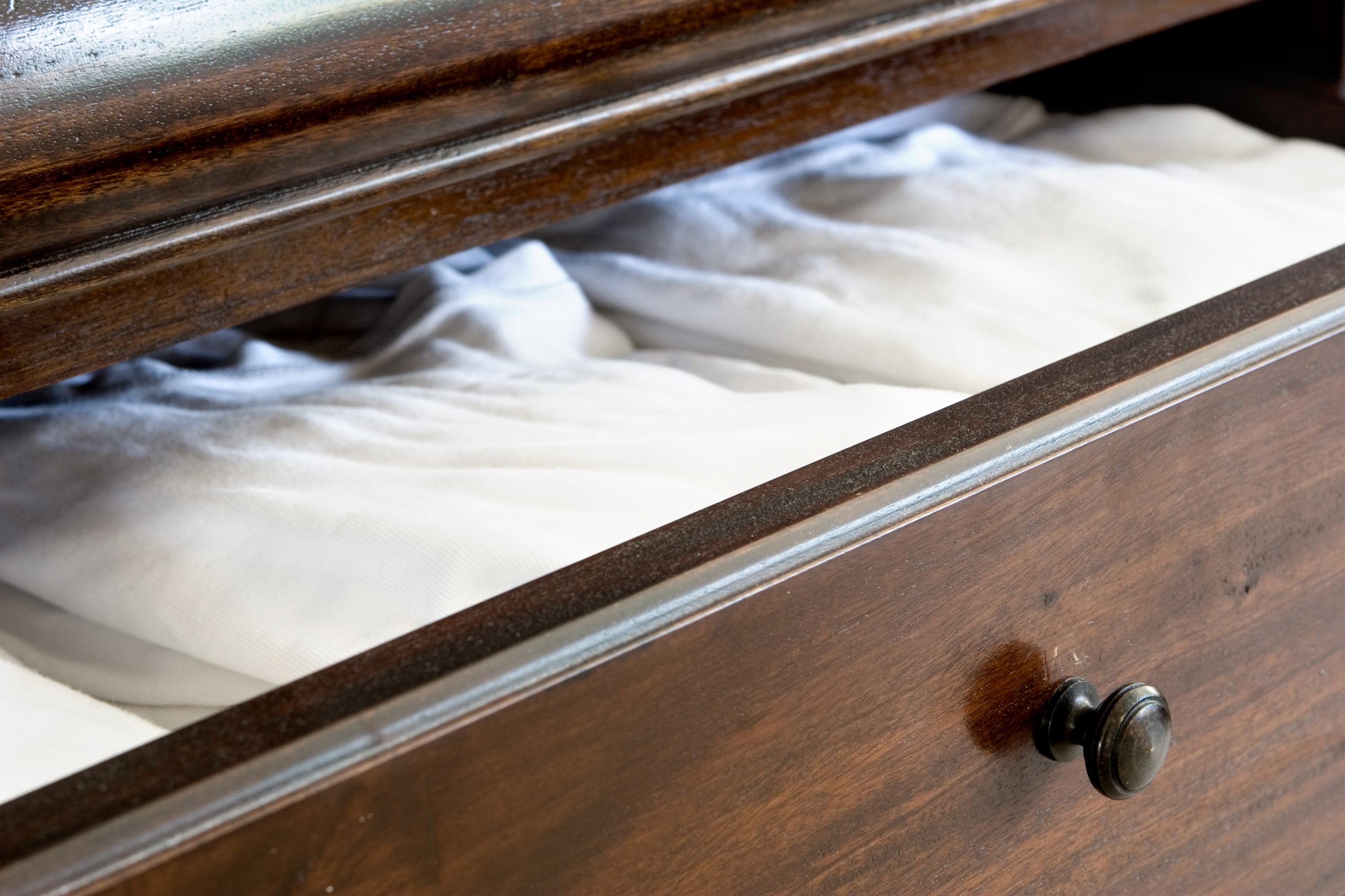 Open wooden dresser drawer | Source: Shutterstock