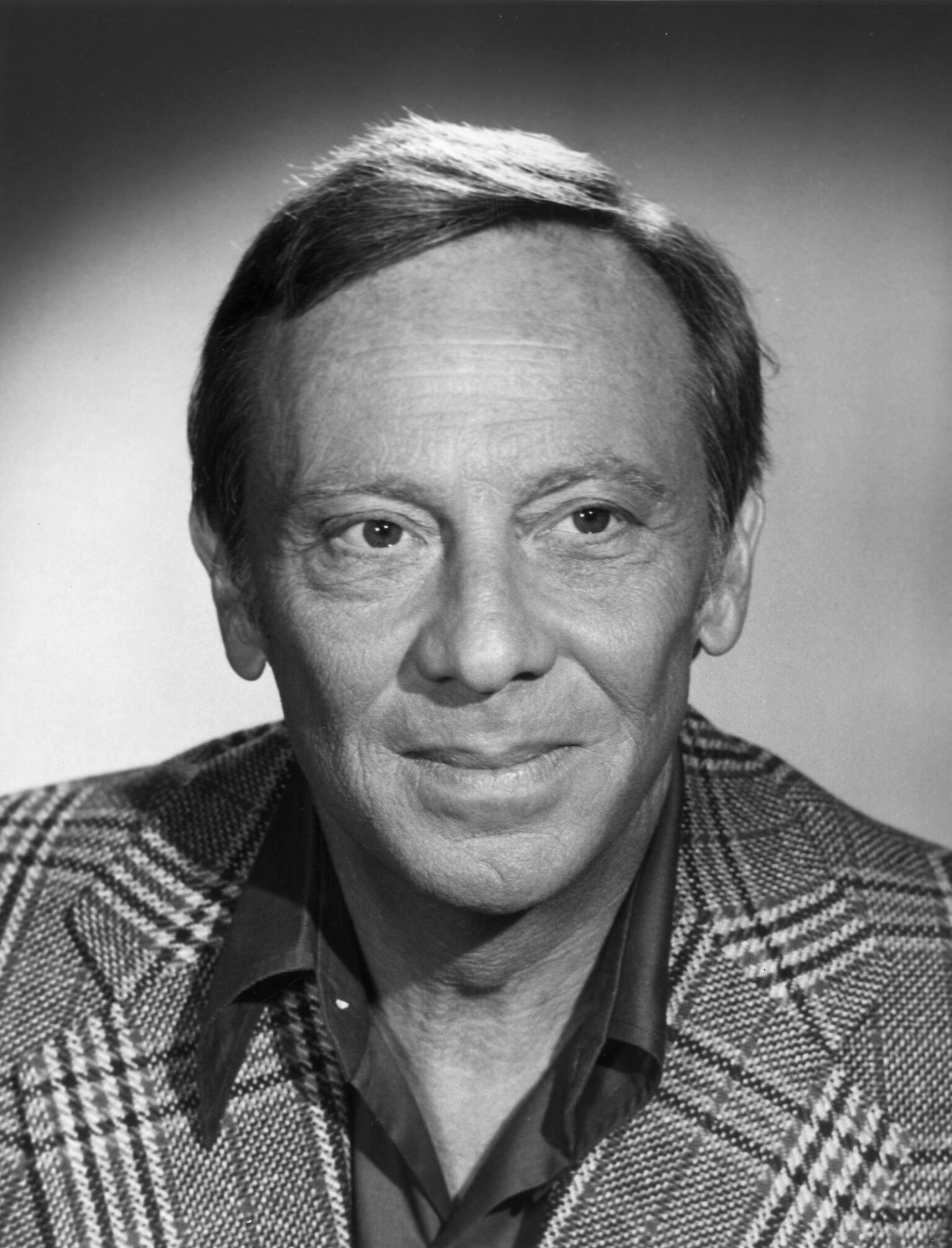 Studio headshot portrait of American actor Norman Fell (1924-1998), wearing a houndstooth blazer. | Getty Images