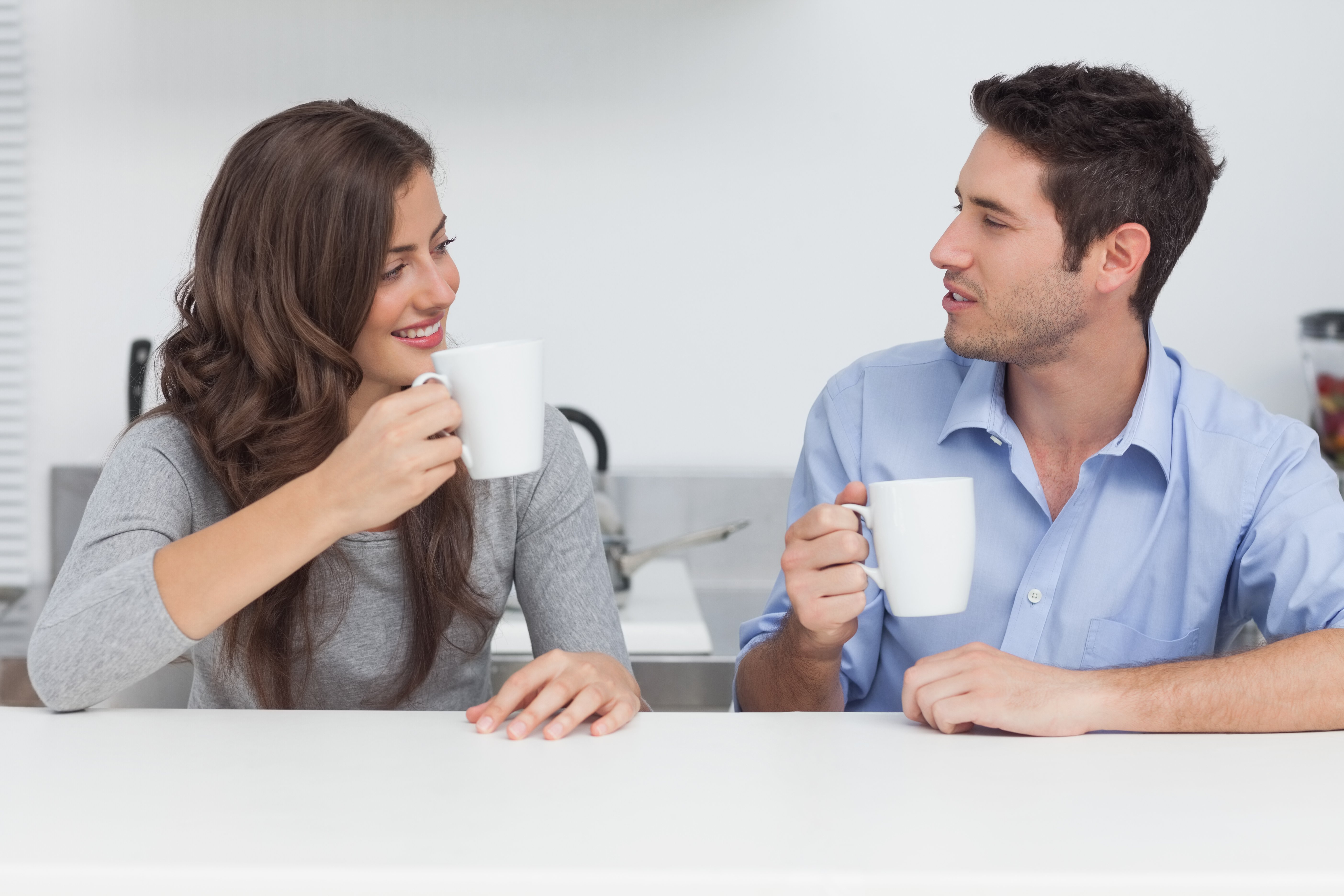Couple drinking coffee in the kitchen | Photo: Shutterstock