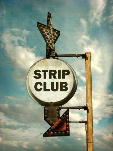A worn Strip Club sign. | Source: Shutterstock.