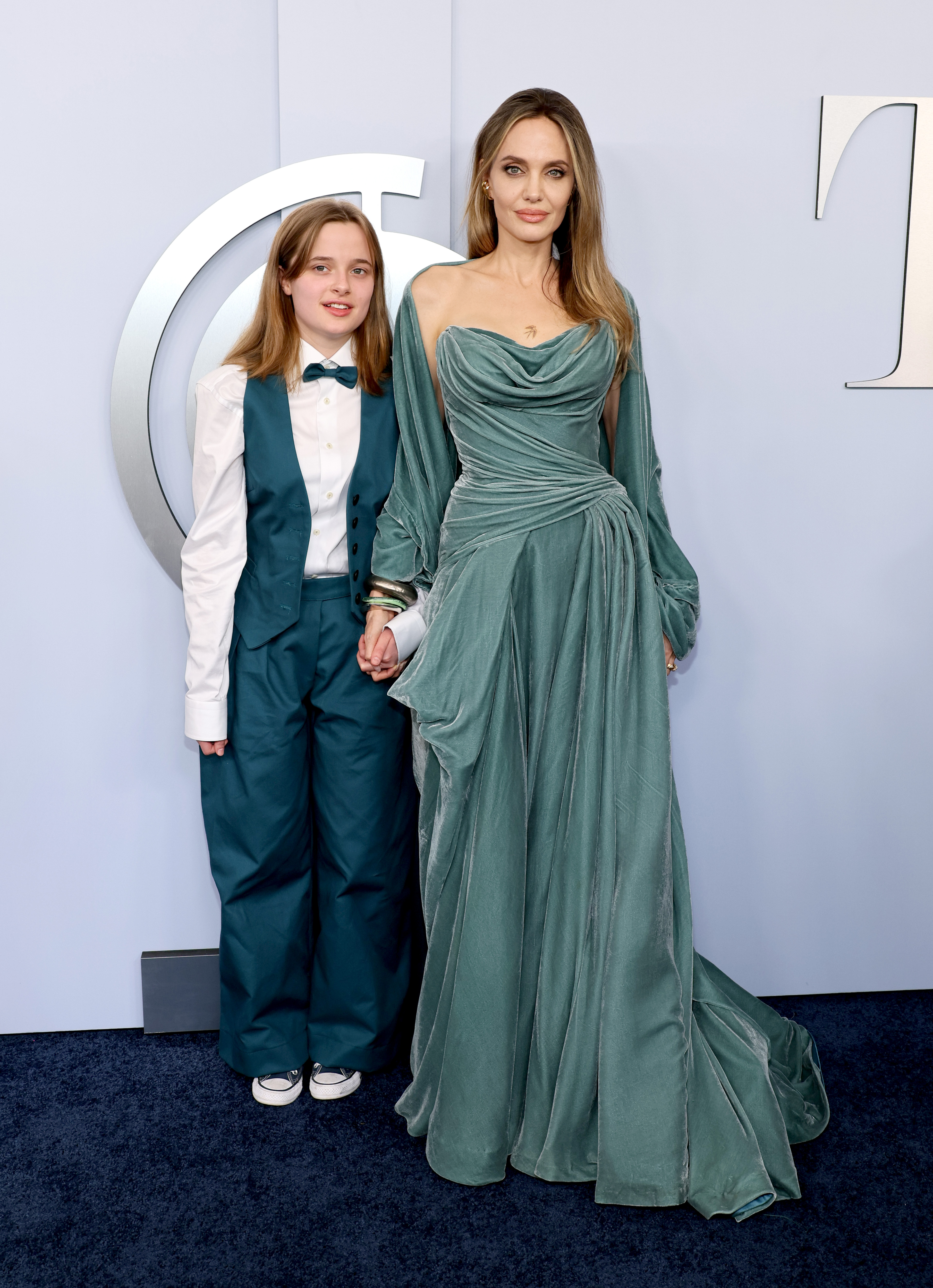 Vivienne Jolie-Pitt and Angelina Jolie stand before the press at the 77th Annual Tony Awards in New York City on June 16, 2024. | Source: Getty Images