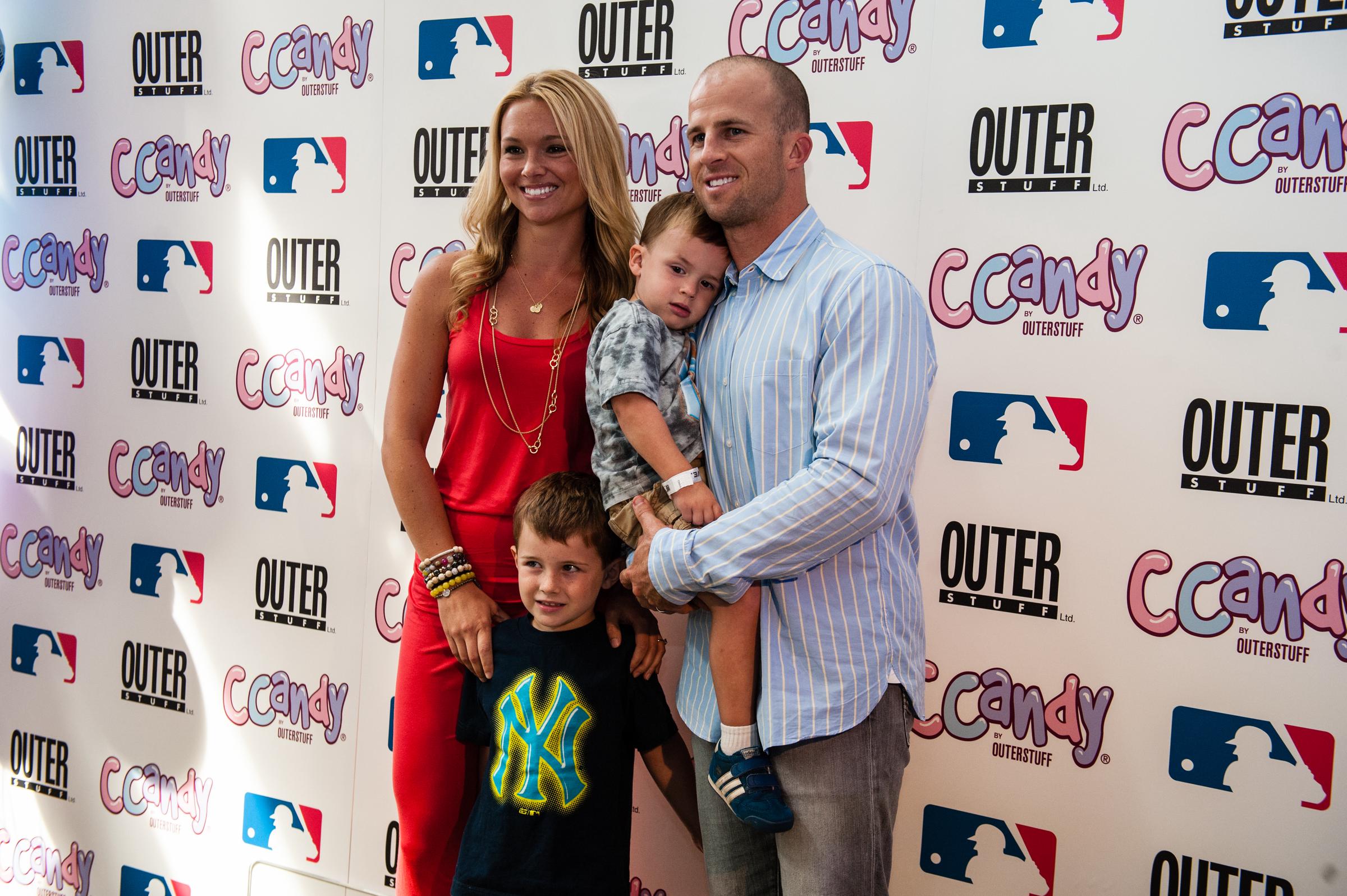 Brett Gardner of the New York Yankees poses with his family prior to the preview of the CCandy line during the CCandy Fashion Show at the MLB Fan Cave, on August 8, 2013, at Broadway and 4th Street in New York City | Source: Getty Images