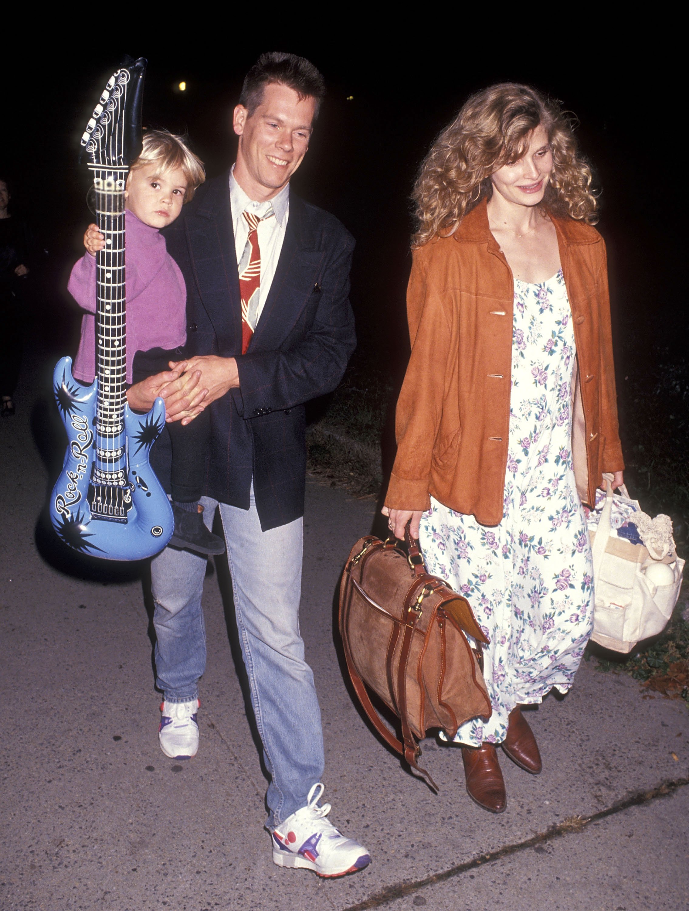 Actor Kevin Bacon with his wife, actress Kyra Sedgwick, and their son, Travis Bacon, attending the Big Apple Circus Special Performance at Damrosch Park, Lincoln Center on October 25, 1991 in New York City ┃Source: Getty Images