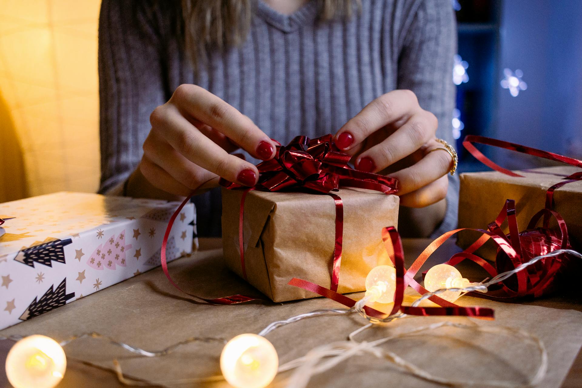 A woman wrapping a gift | Source: Pexels