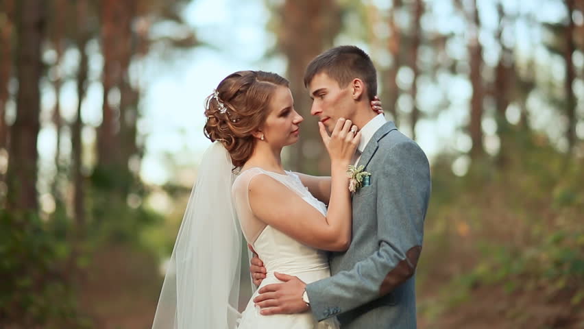 Photo of a young couple in their wedding dress with forest as the background | Photo: Shutterstock