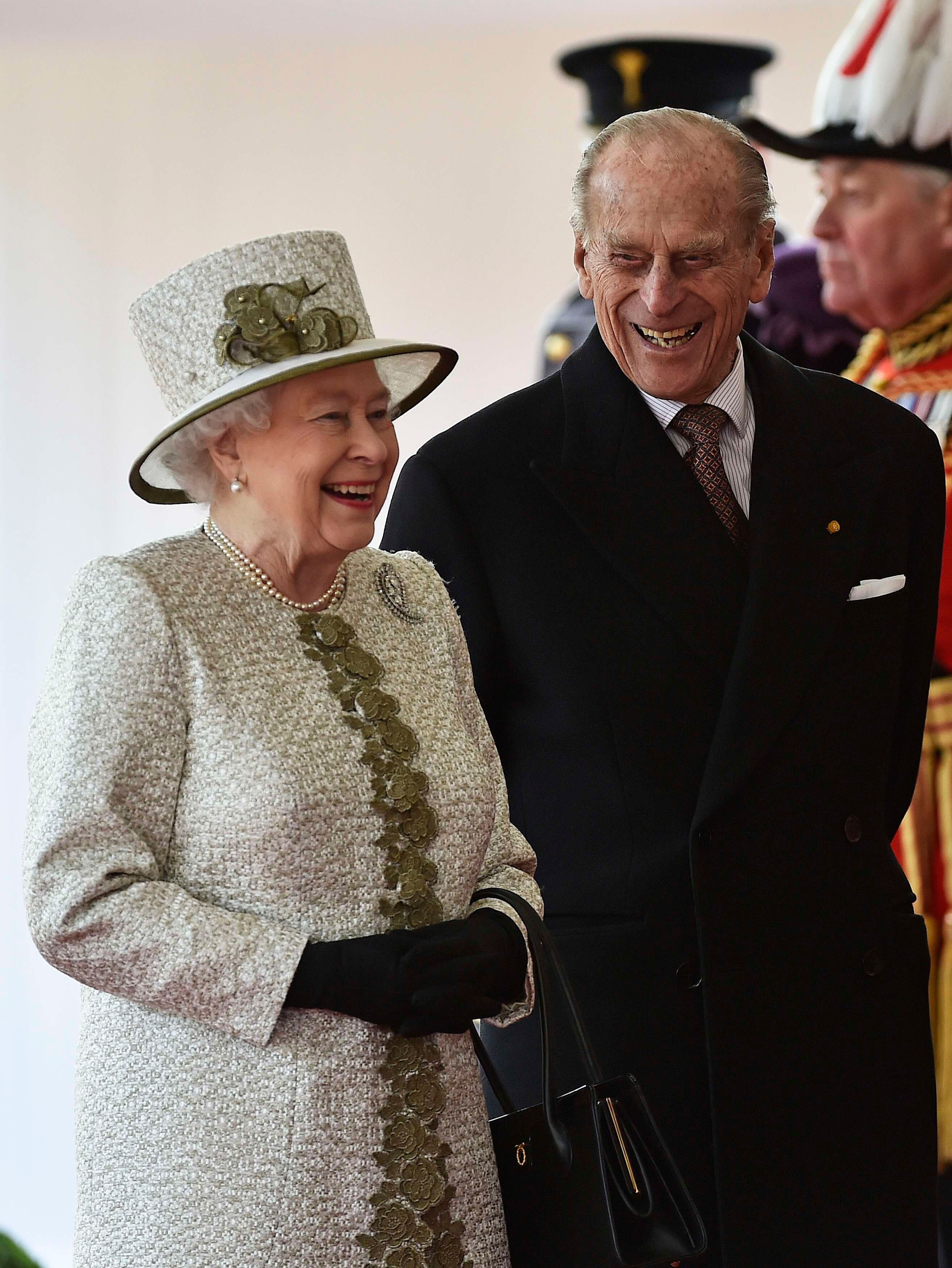 Queen Elizabeth II and Prince Philip, Duke of Edinburgh laugh during a ceremonial welcome for the State Visit of The President of The United Mexican, Senor Enrique Pena Nieto and Senora Rivera at Horse Guards Parade. | Source: Getty Images