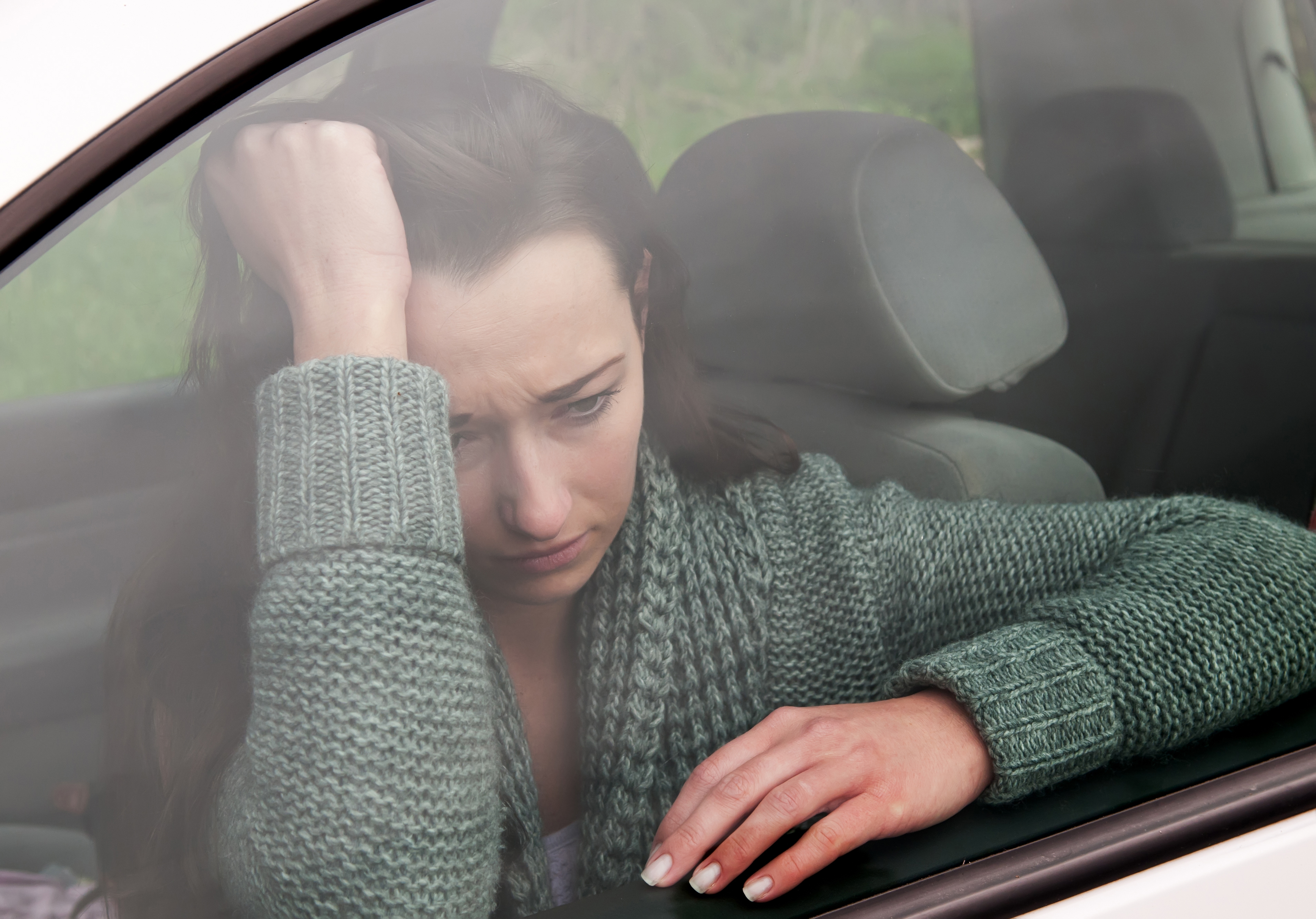 Sad young woman in the car | Source: Shutterstock