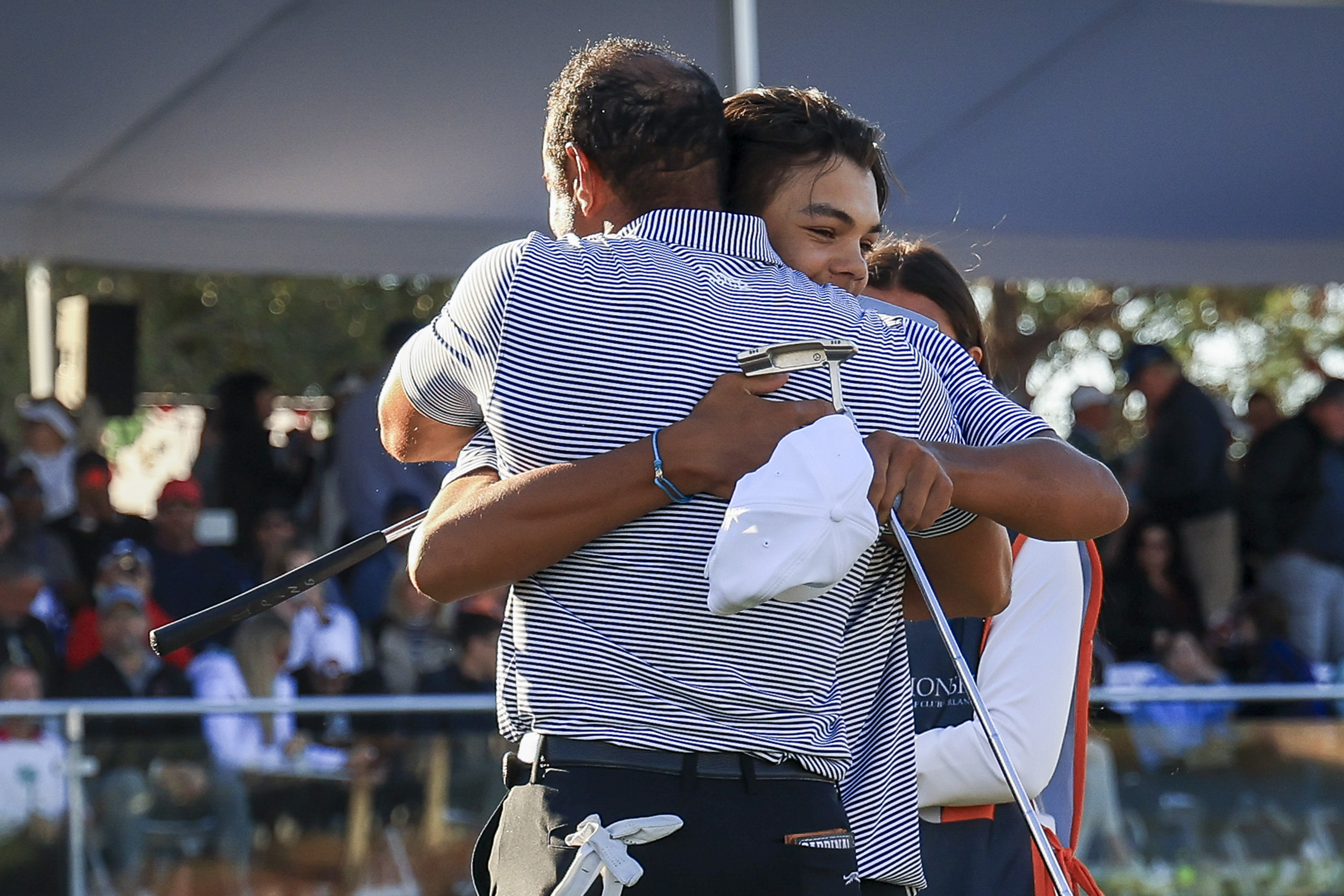 Charlie Woods hugs his father Tiger Woods on December 21, 2024, in Orlando, Florida | Source: Getty Images