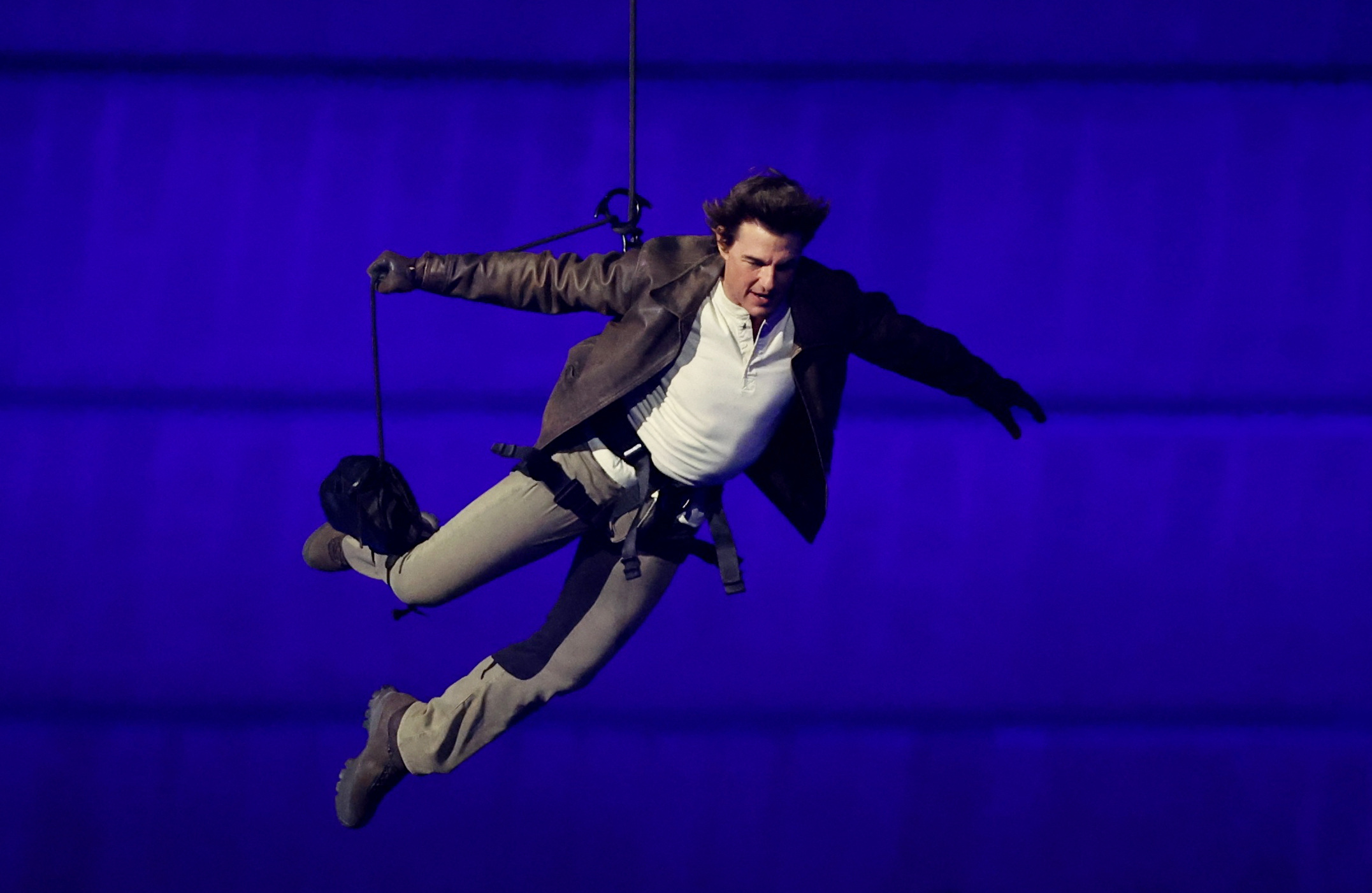 Tom Cruise jumps from the roof of the Stade de France during the Closing Ceremony of the Paris 2024 Olympic Games at Stade de France on August 11, 2024, in Paris, France. | Source: Getty Images