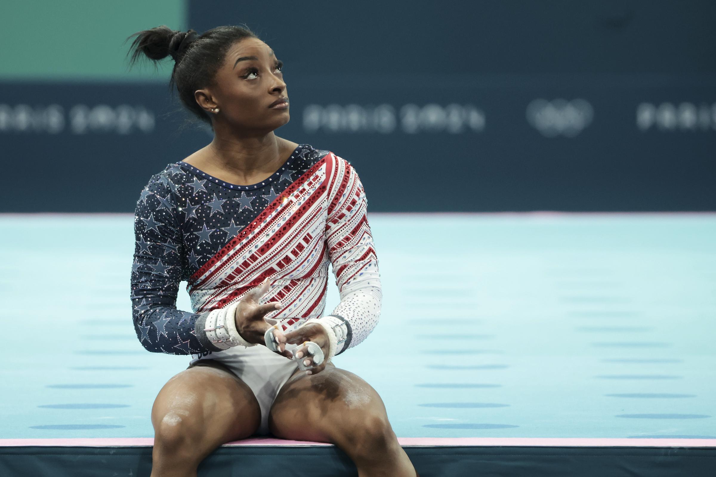 Simone Biles prepares for the uneven bars during the Artistic Gymnastics Women's Team Final at the 2024 Paris Olympics in Paris, France on July 30, 2024 | Source: Getty Images