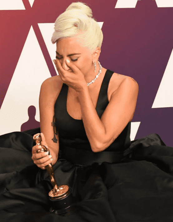 Lady Gaga sits on the floor in her gown and cries after receiving an oscar at the 91st Annual Academy Awards, on February 24, 2019,  in Hollywood, California | Source: Getty Images (Photo by Steve Granitz/WireImage )