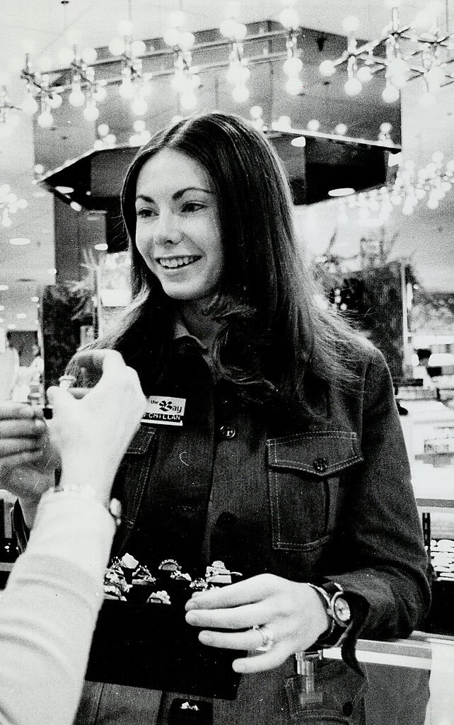 Actress Heather Summerhayes serves customer at jewellery counter of Bay Co. on January 22, 1975. | Photo: Getty Images