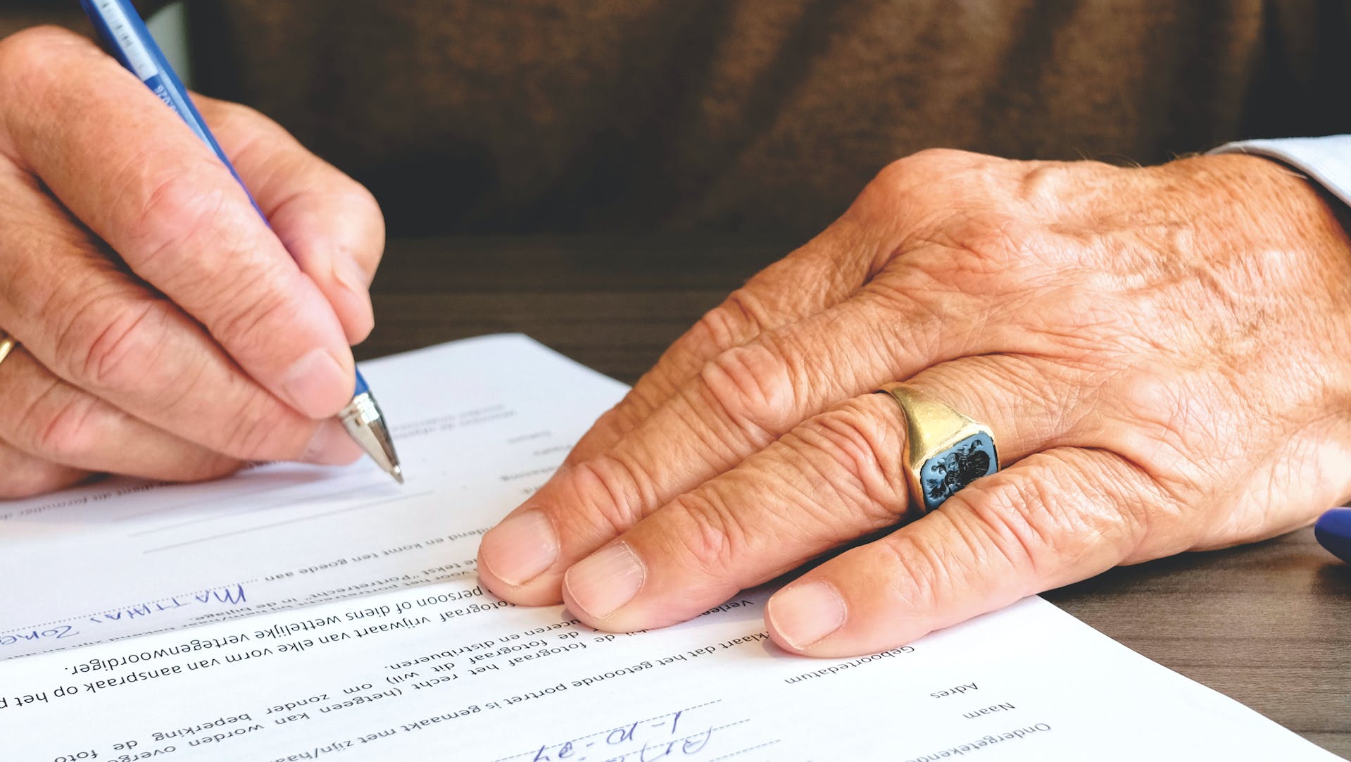 A man signing a document | Source: Pexels