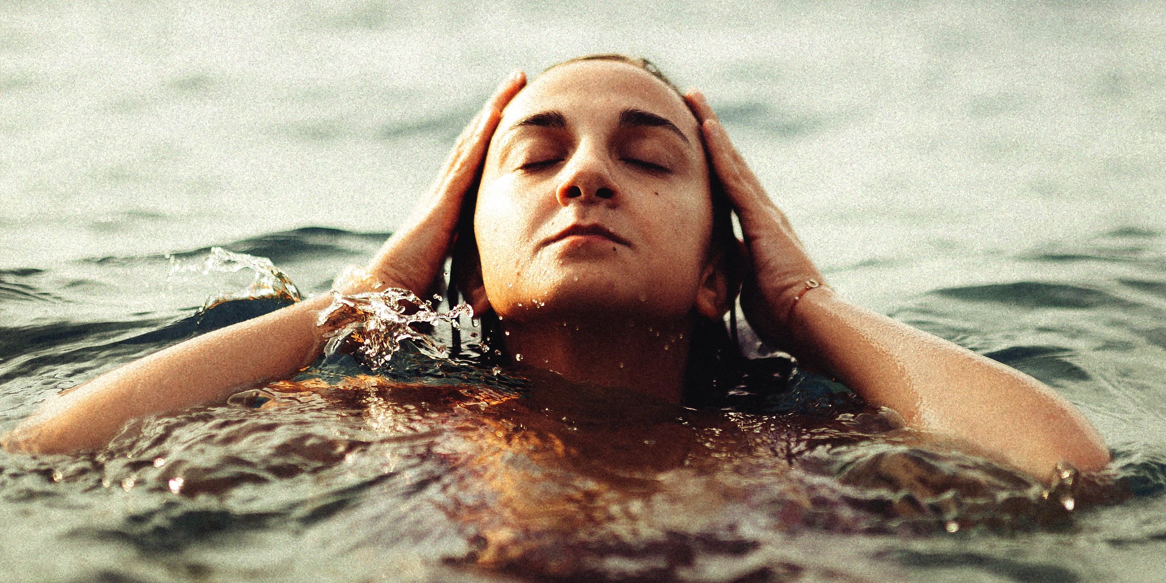 Unsplash | Woman holding head out of water
