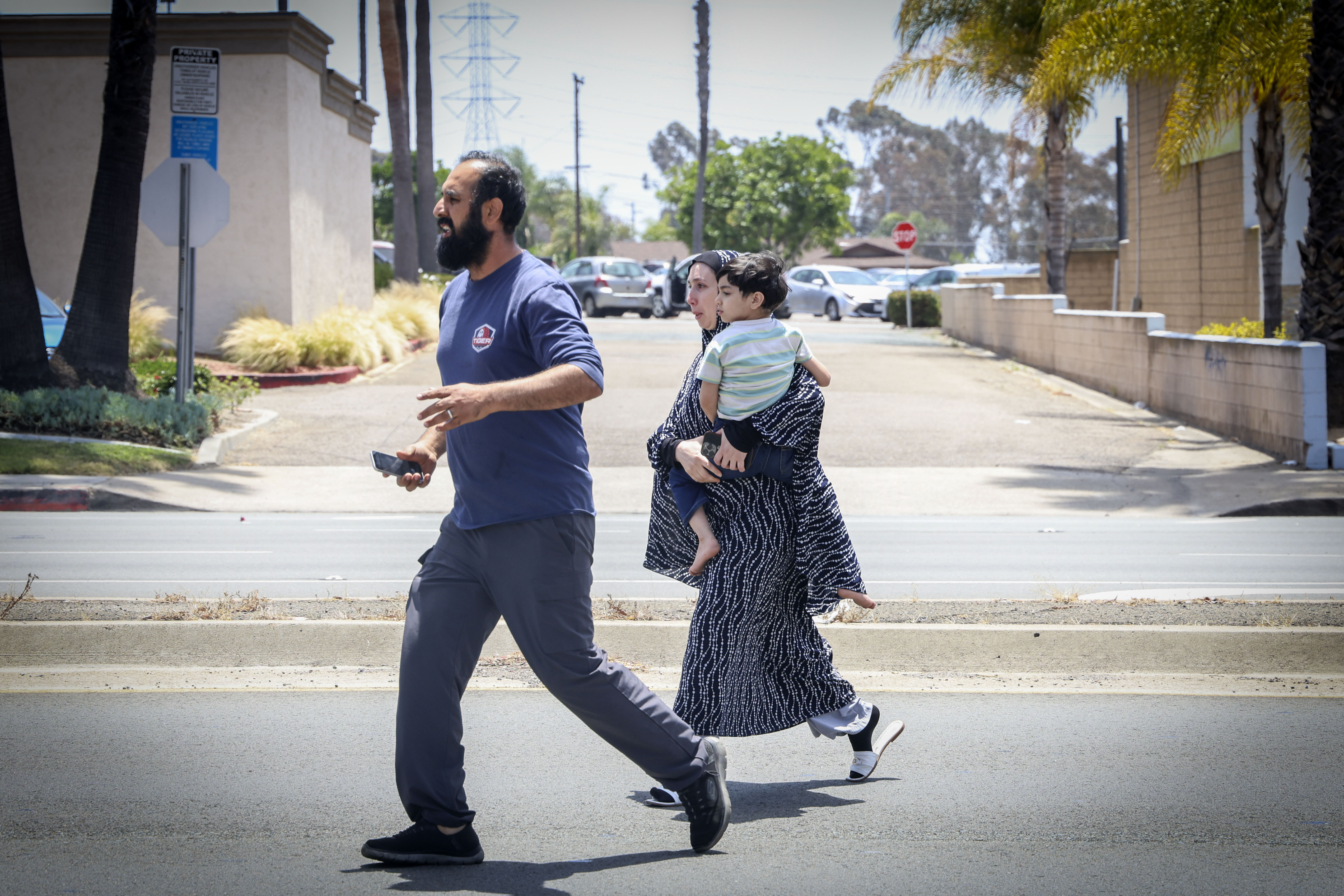 Families evacuate the area surrounding the Islamic Center of San Diego on May 18, 2026 | Source: Getty Images